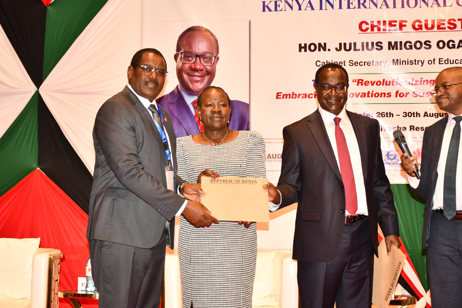 Ministry of Education Cabinet Secretary Julius Ogamba [right] with her counterpart PS in charge of TVETs Dr. Esther Muoria [center] hands over letters of deployment of trainers to Nyeri Technical Institute Principal David Mwangi who are part of 2,000 trainers the government  has dispatched to 242 TVET institutions to boost quality training in a ceremony held in Naivasha.