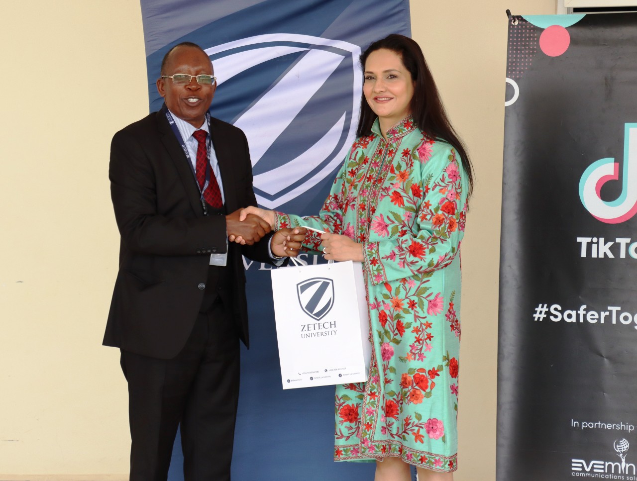 Zetech Vice Chancellor Prof Njenga Munene gifts the Head of Public Policy Programs at TikTok for the Middle East, Africa, Turkiye, Pakistan & South Asia Ms. Zara Higgs.