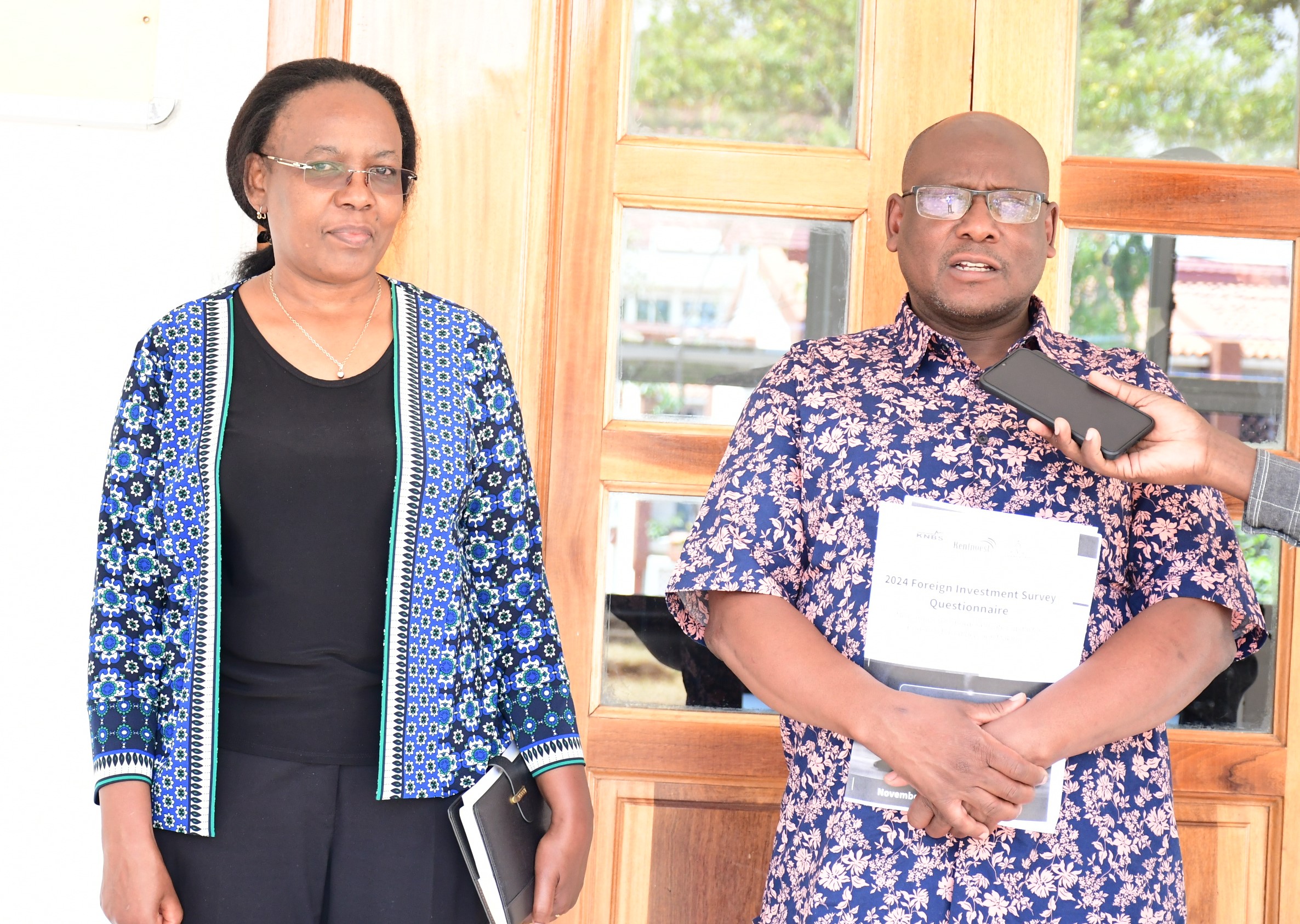 Director Statistical Coordination and Methods at KNBS, Benjamin Avusevwa (R) addresses the press during the closing ceremony of a 10-day training of research assistants in Kisumu County. Photo/Robert Ojwang’