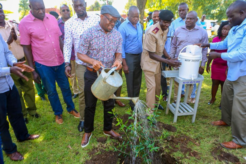 State Department for Interior Principal Secretary Dr Raymond Omollo waters a tree during a Chief's tree planting exercise. 