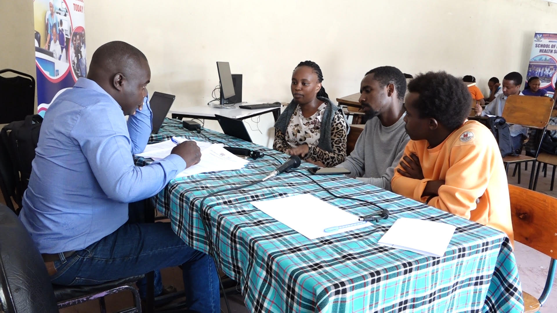 Senior research scientist at The Kenya Industrial Research and Development Institute  (KIRDI) attached to the Directorate of Technology Transfer and Extension Services Mr  Winstone Nyaguti (Left) takes young innovators on the training over to need to patent  their inventions.