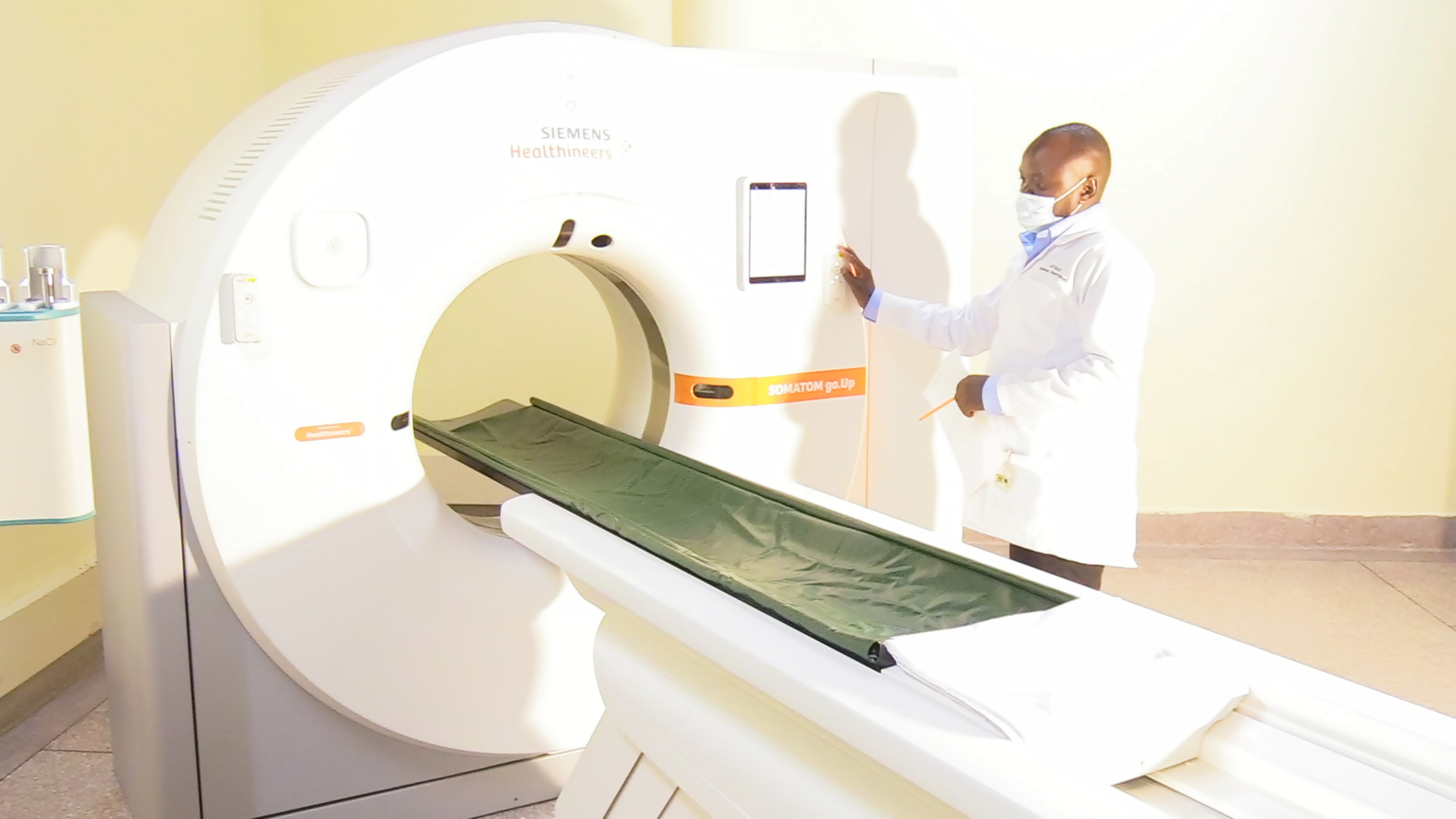 A doctor at the Kilifi County Referral Hospital illustrates how the 64 slice CT scan machine works. 