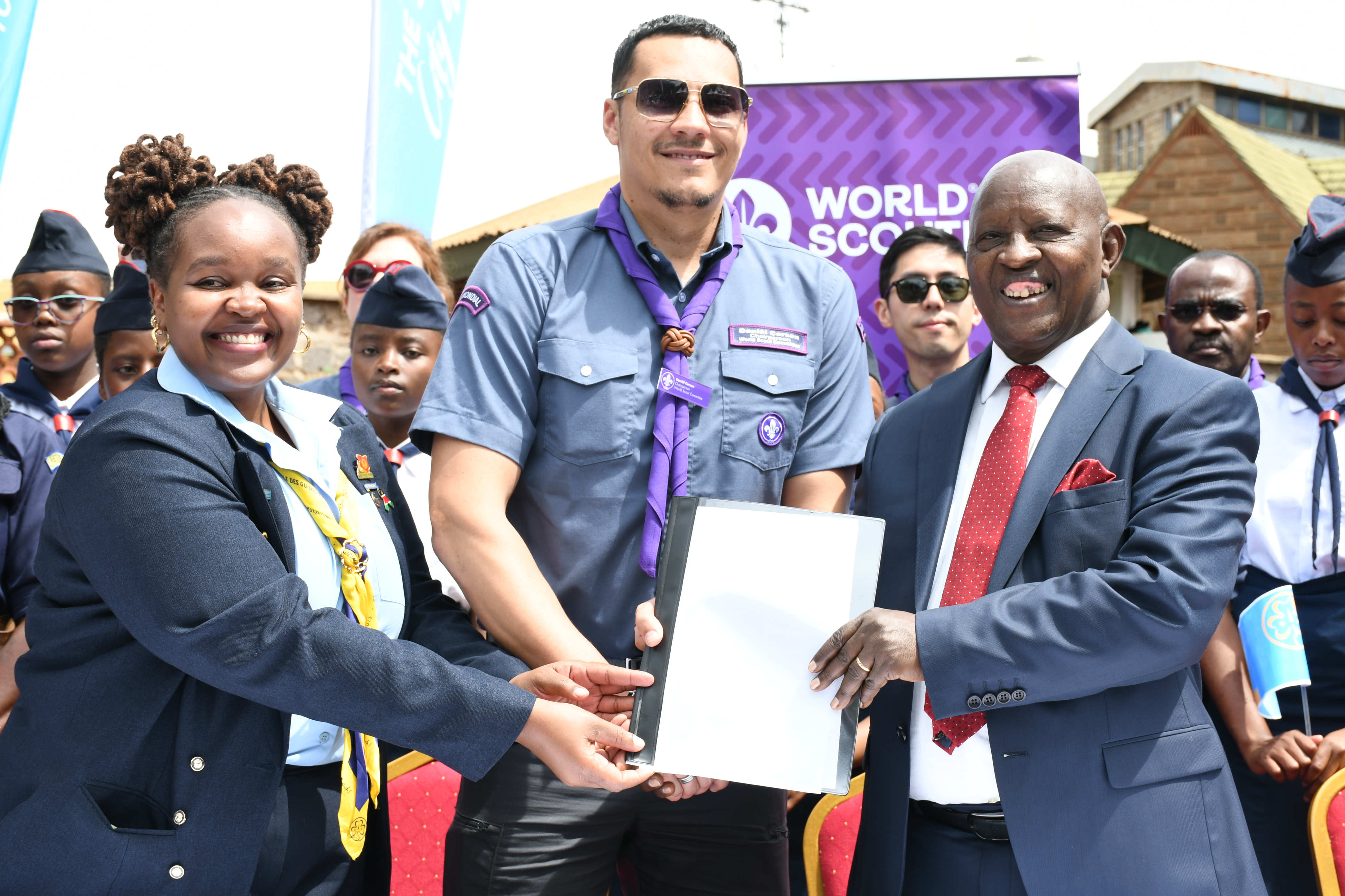 World Scouts and Guides Board assistant chairperson,  Josephine Mwangi, Daniël Corsen, chairperson of World  Scout committee (centre) presents a declaration desig nating Nyeri County as the official global scouting city  of the world to Nyeri Governor Dr. Mutahi Kahiga 