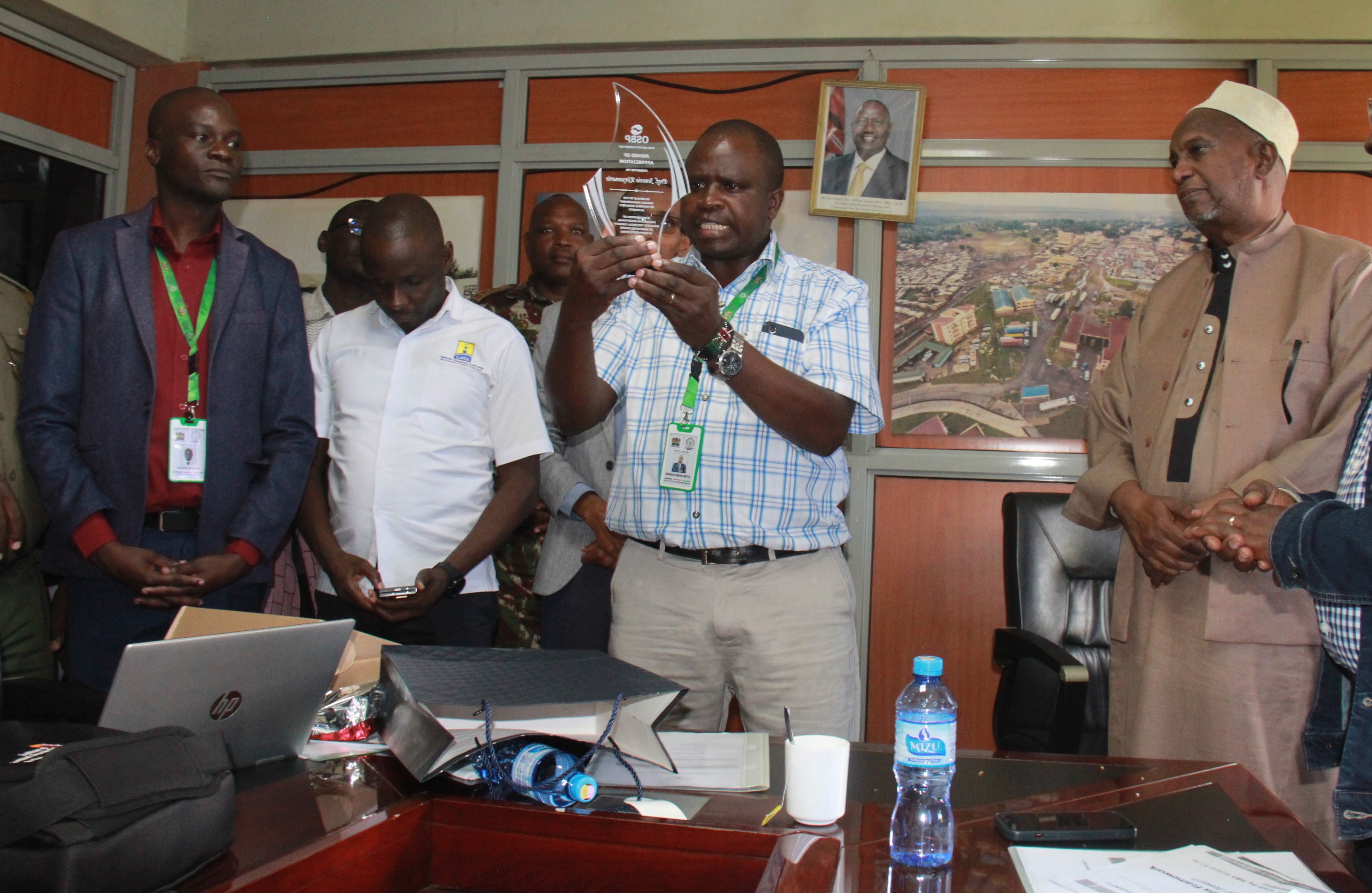 National Biosafety Authority Ag. CEO Nehemiah Ngetich displaying a gift awarded to the Authority by Kenya Revenue Authority for their good service
