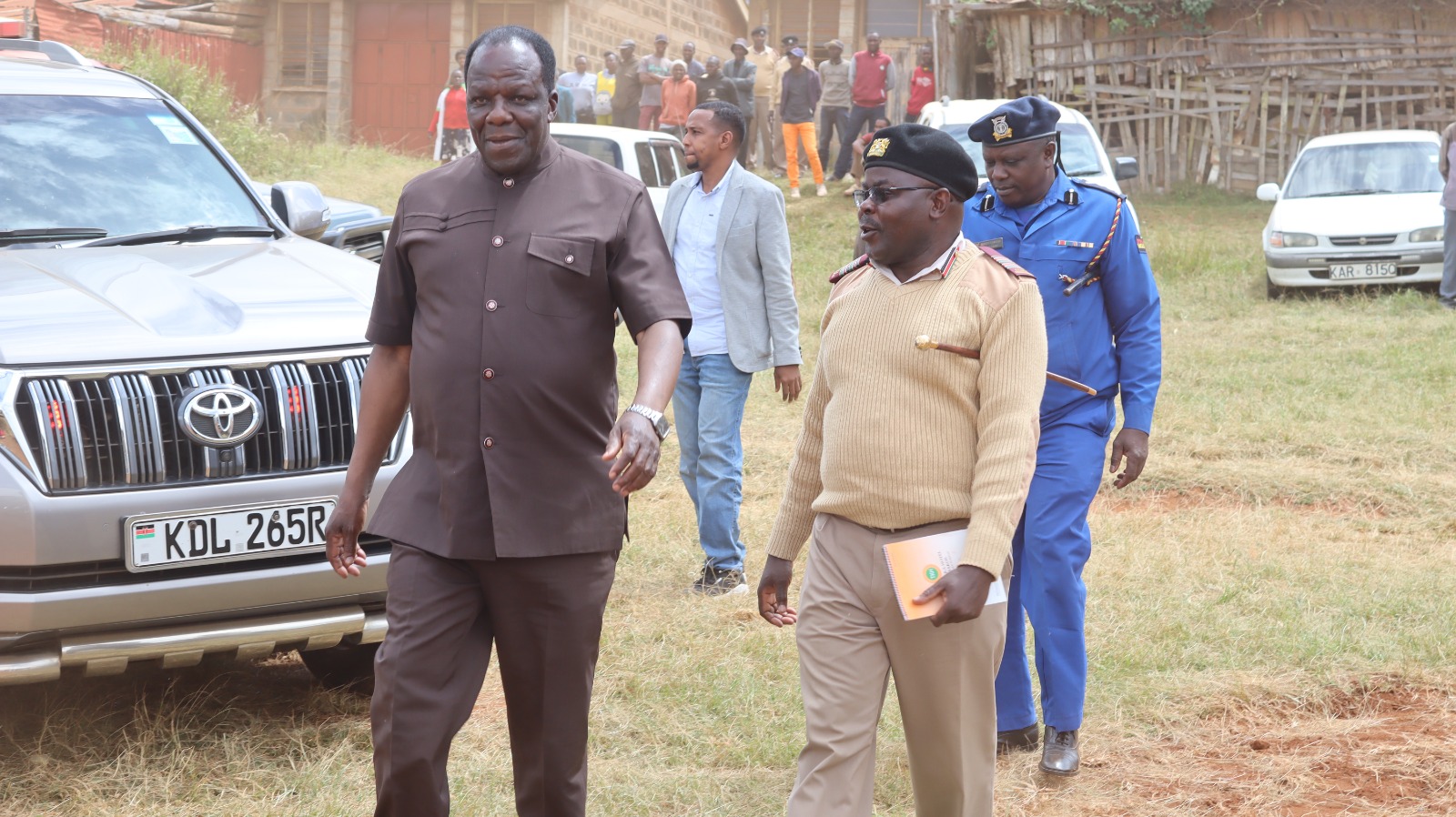 Cooperatives Cabinet Secretary, Wycliffe Oparanya,  is escorted by Mbooni West DCC, Stanlaus Apwoka, at  Kikima town, where he addressed farmers