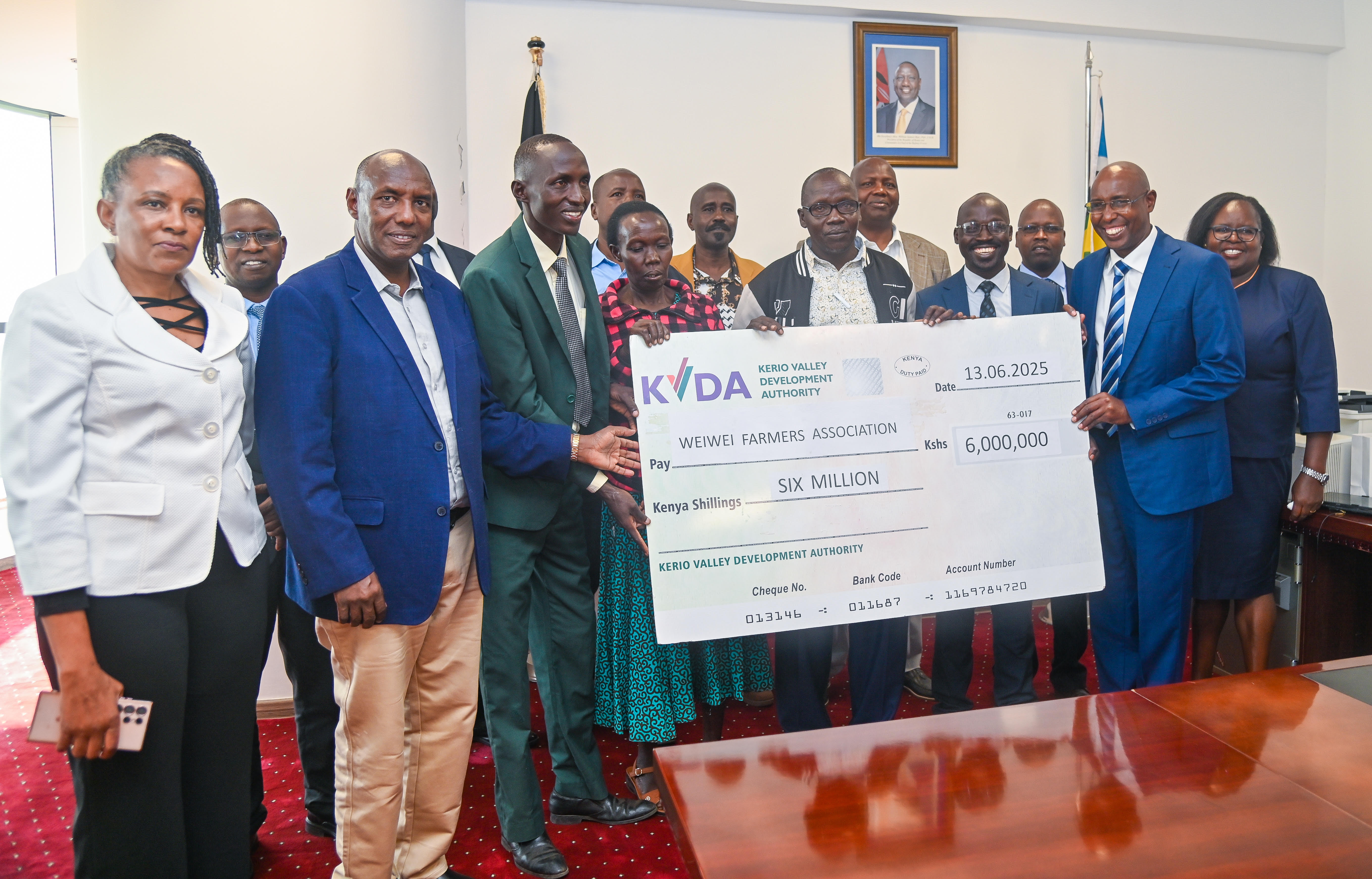  PS State Department for ASALs and Regional Development Kello Harsama handing over  the cheque of 60M to Weiwei Farmers. 