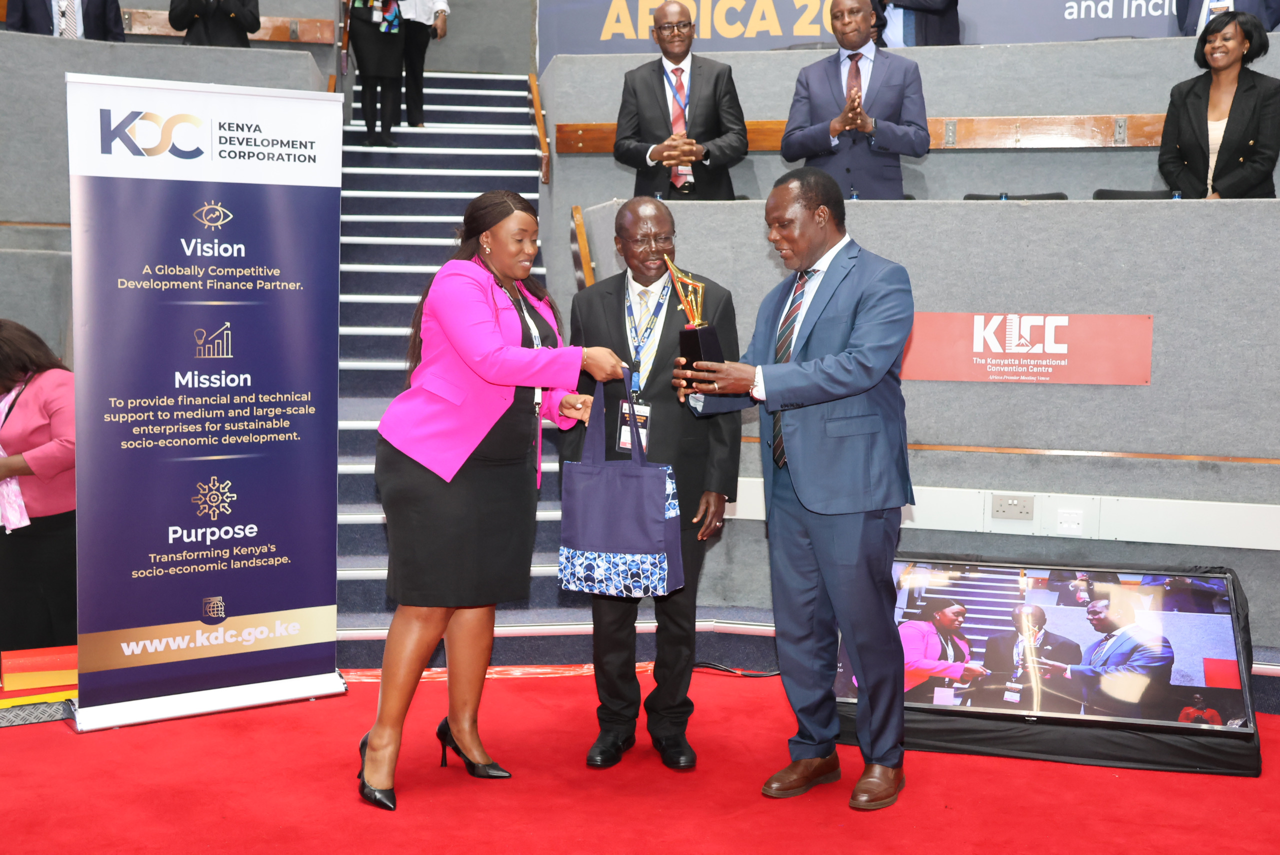 Principal Secretary (PS) for Industry, Dr. Juma Mukhwana (R) Kenya Development Corporation (KDC) Board Chair Sakwa Bunyasi and KDC CEO, Norah Ratemoh, having a chat at Next Frontier Africa 2025 summit at KICC. Photo/Jared Nyabuti