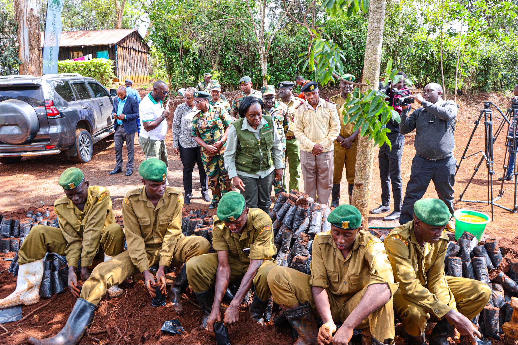 Environment, Climate Change and Forestry Cabinet Secretary Dr Deborah Barasa (standing in the middle) engages National Youth Service (NYS) officers potting seedlings under the 15-billion tree-growing campaign during a briefing at Ngong Hills Forest Station.