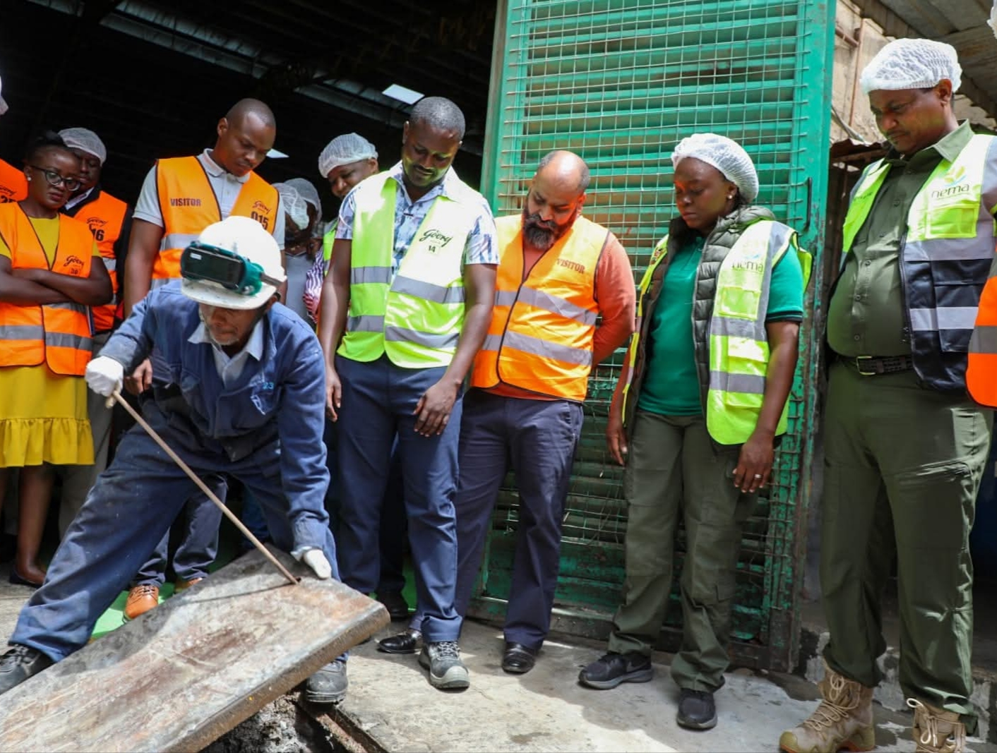 Cabinet Secretary for Environment, Dr Deborah Barasa (2nd right), Dr Mamo B Mamo NEMA Director General (far right) with staff of Canon Chemicals who manufacture soap and beauty products in Mlolongo during an inspection tour of effluent discharges into Nairobi Rivers. PHOTO: ANNE KANGERO