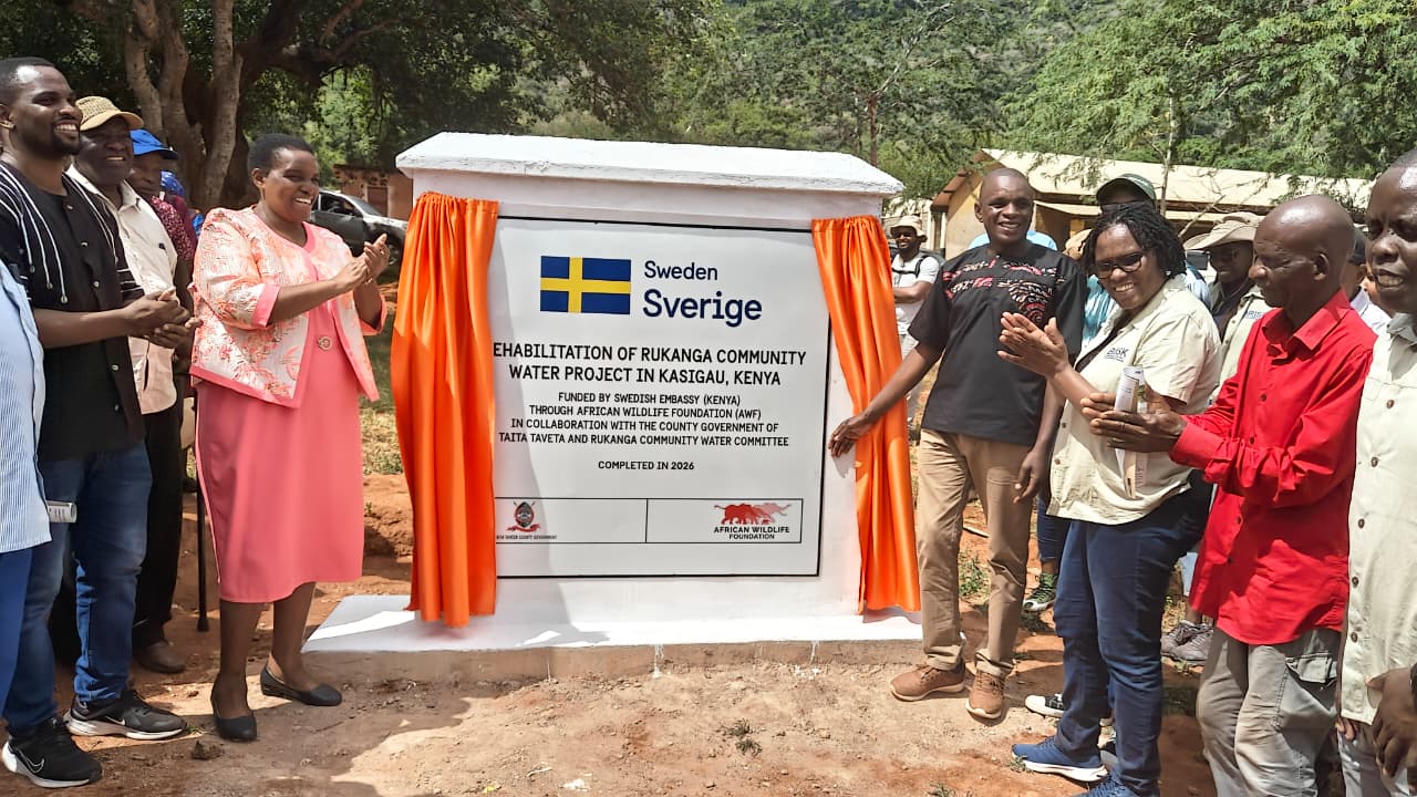 Taita Taveta County Deputy Governor Christine Kilalo (Left) claps after commissioning of the Rukanga Sh4.6 million water project at Kasigau, Taita Taveta.