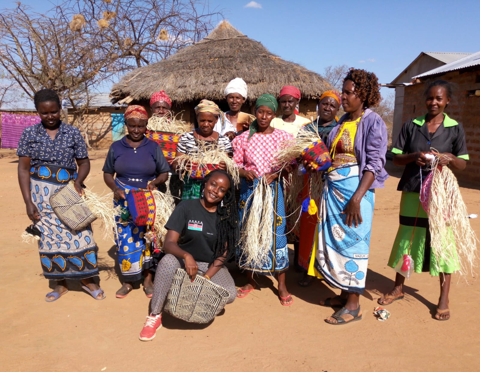 Sheila Atieno Onyango (squatting in black t-shirt) poses for a photograph with some of the women she works with. PHOTO: PAMELLA DOROTHY