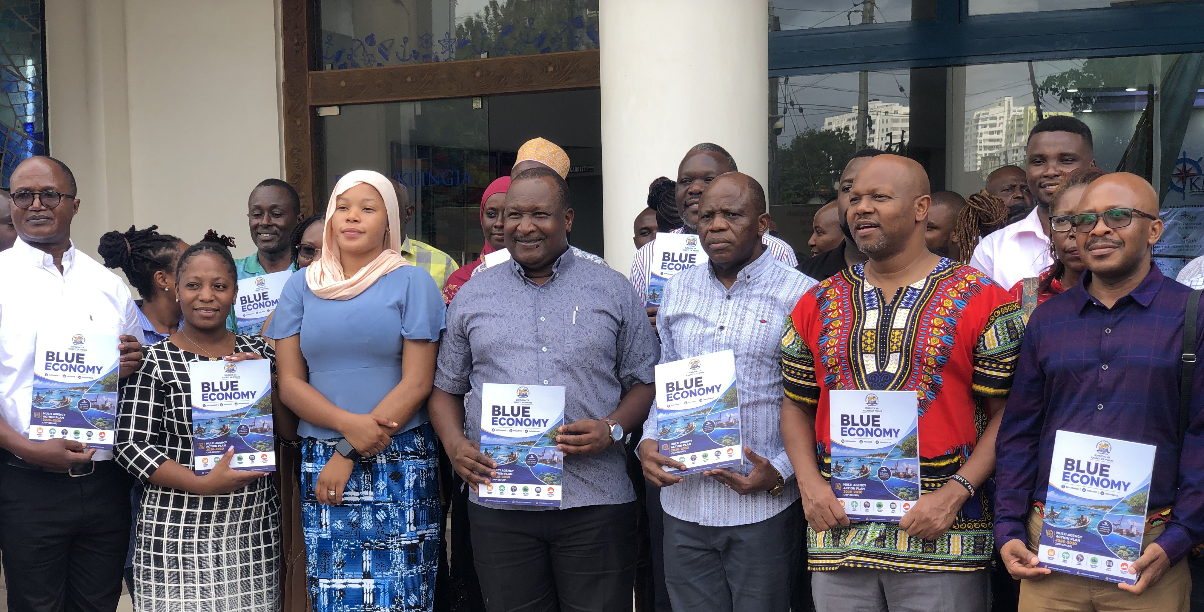 Officials display copies of the newly launched Jumuiya ya Kaunti za Pwani (JKP) Blue Economy Multi-Agency Action Plan (JKP-BEMAP) 2026- 2030, a Sh156 billion ($1.2 billion) roadmap for jobs, climate resilience and shared prosperity across Kenya’s six coastal counties, during the launch ceremony in Mombasa. PHOTO: RAMADHAN NASSIB