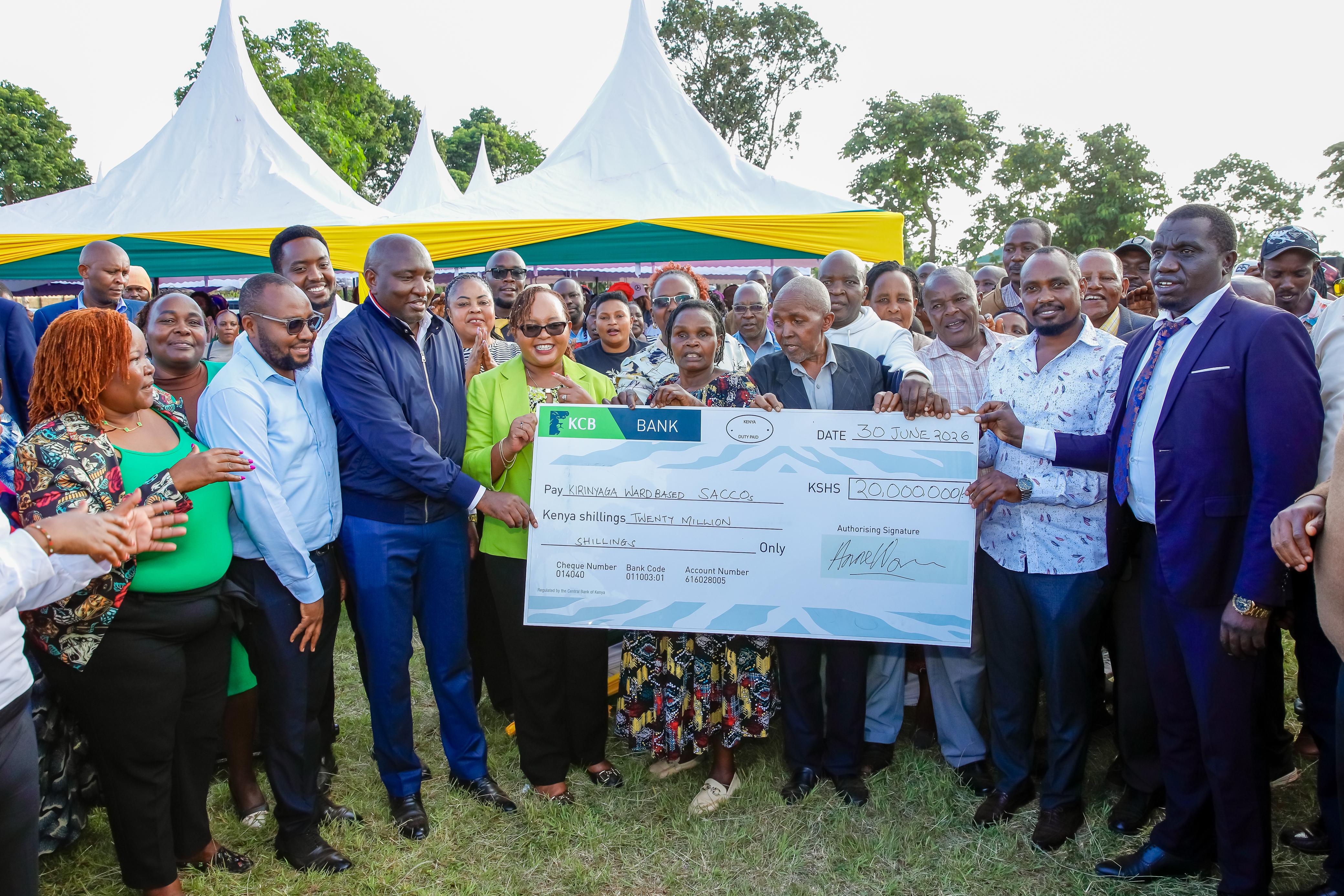 Kirinyaga County Governor Anne Waiguru (fourth from left), together with community group leaders and other Kirinyaga leaders, hold a dummy cheque during the issuance of empowerment funds to ward-based Saccos.