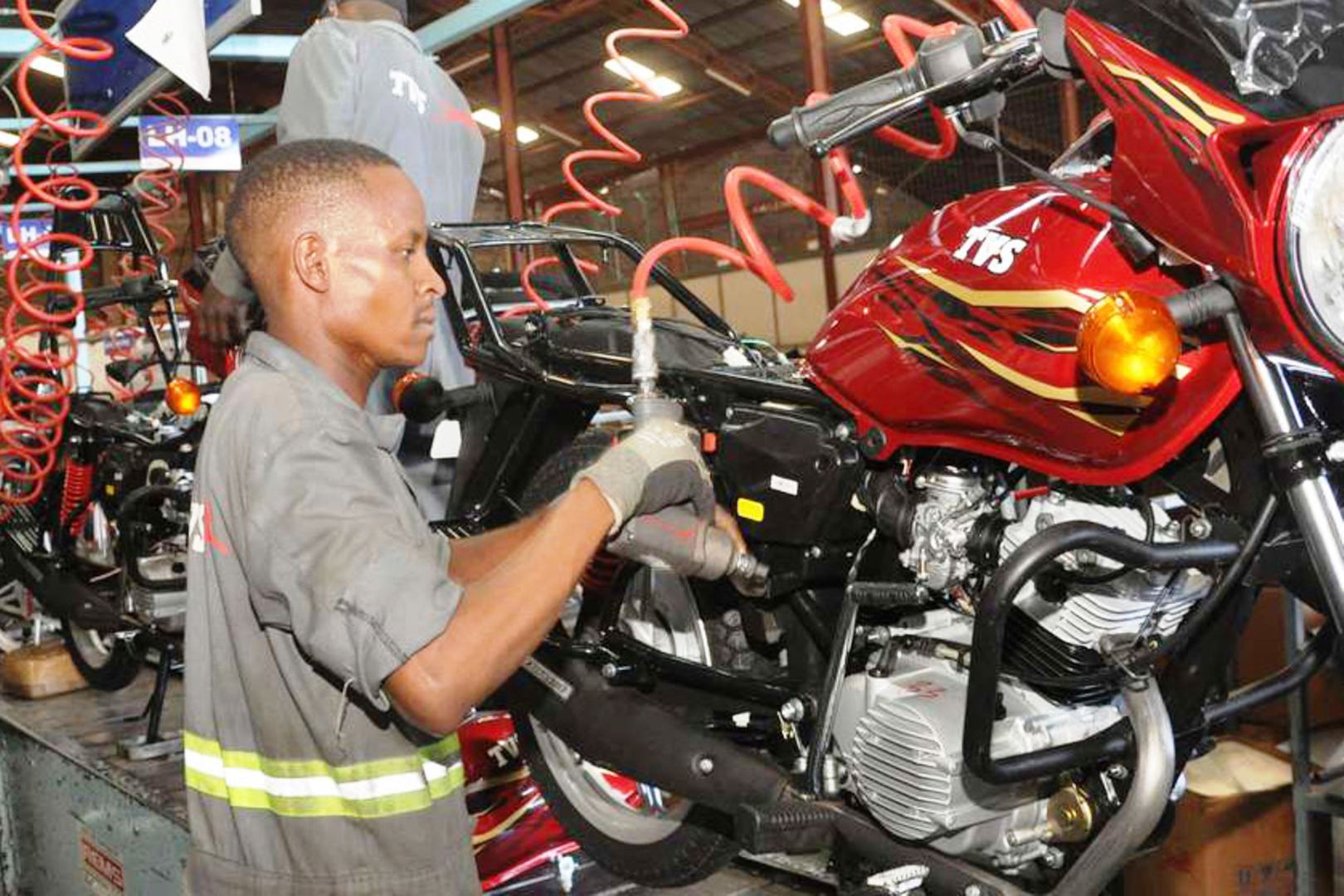 Brian Ouma refurbishing an old motor-cycle at his garage in Mamboleo area in Kisumu.