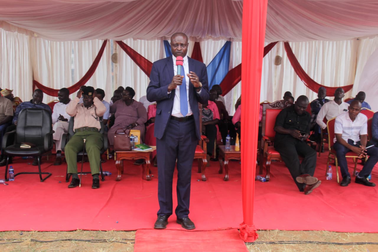 The Director in the State Department for East African Community Affairs, Musa Okwemba, addressing stakeholders at Busia Vocational Training Centre grounds.