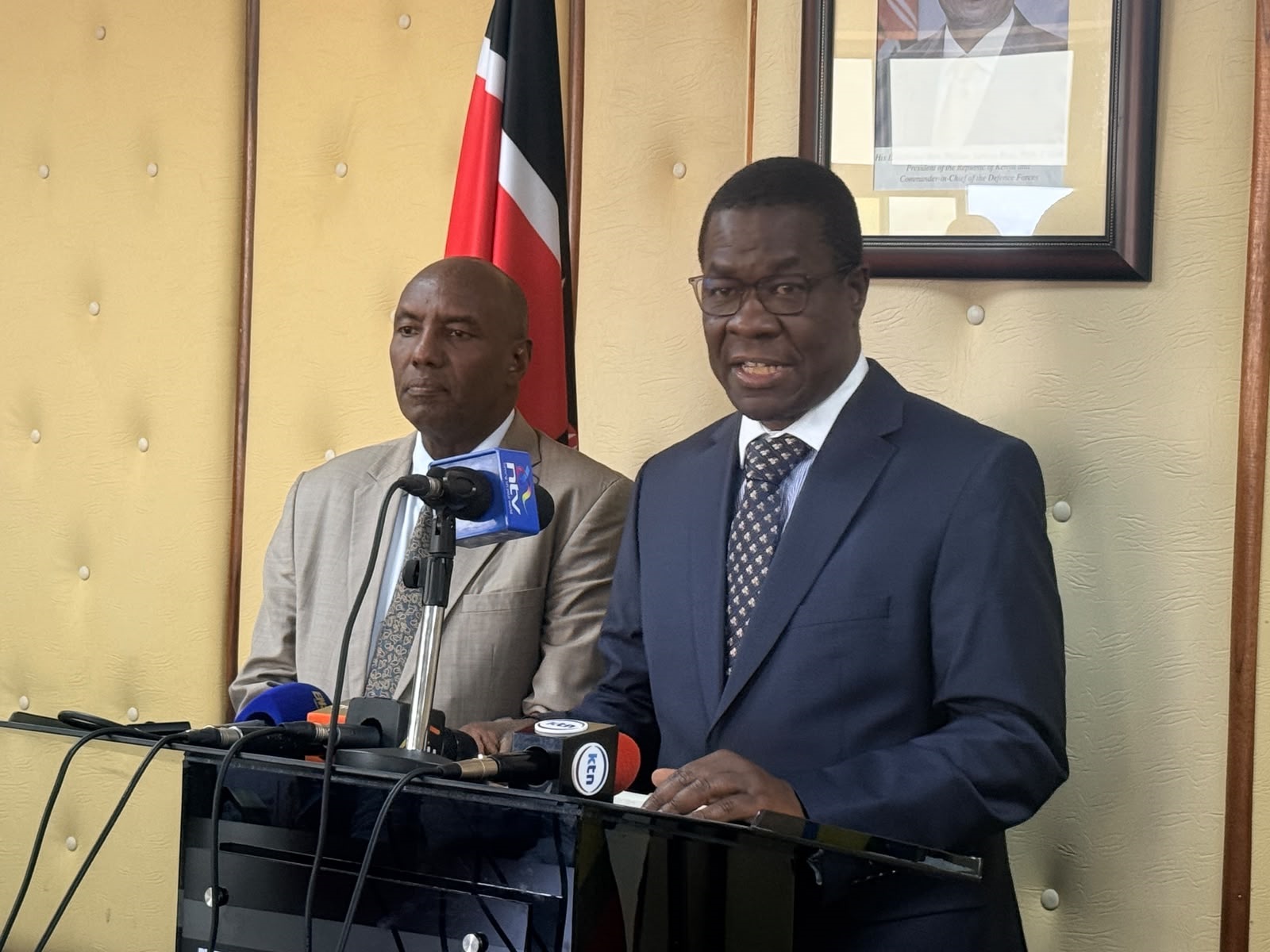 Energy and Petroleum Cabinet Secretary Opiyo Wandayi (right) speaking on global energy markets at KASNEB Towers in Nairobi.