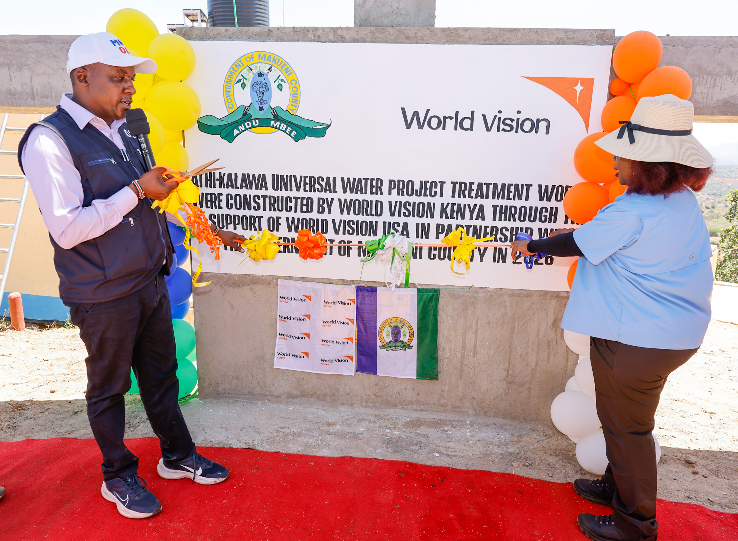 Makueni Governor Mutula Kilonzo Jr. (left) and World Vision East Africa Regional Director Lilian Dodzo commissioning the Sh450 million Athi-Kalawa Water Supply (AKWASH) Project in Kwakiliu in Kalawa Ward, Mbooni East Sub County.