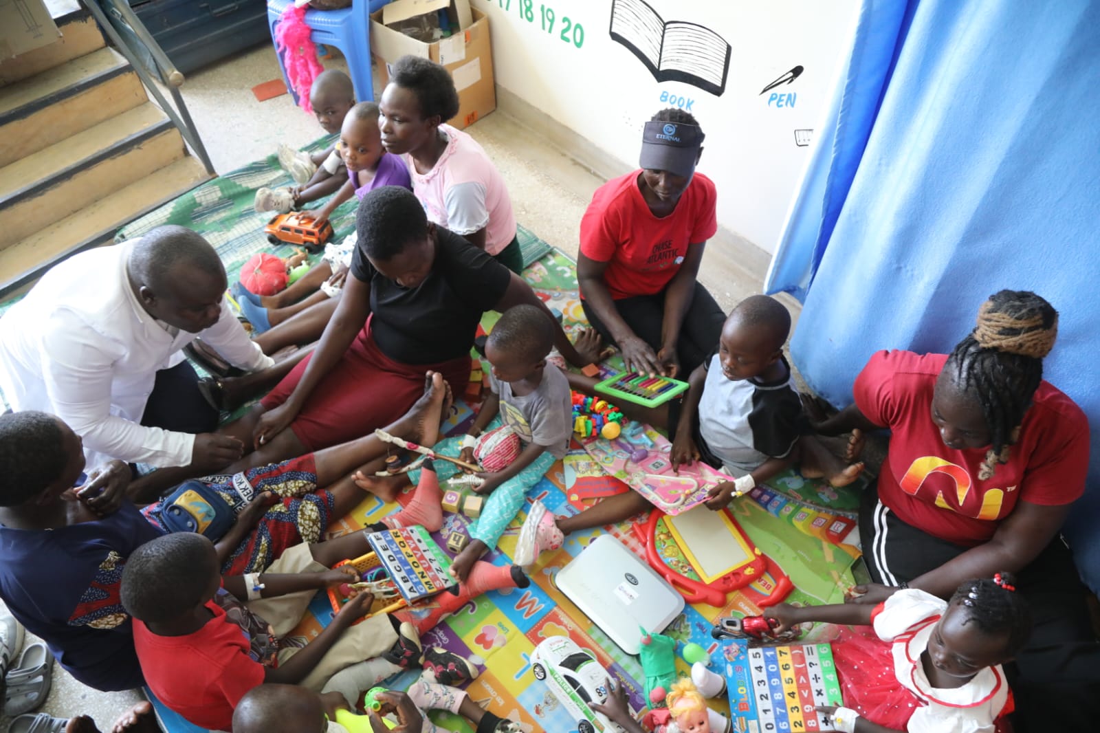 Children playing with their parents in a playroom at the children’s ward in Homa Bay County Teaching and Referral Hospital.