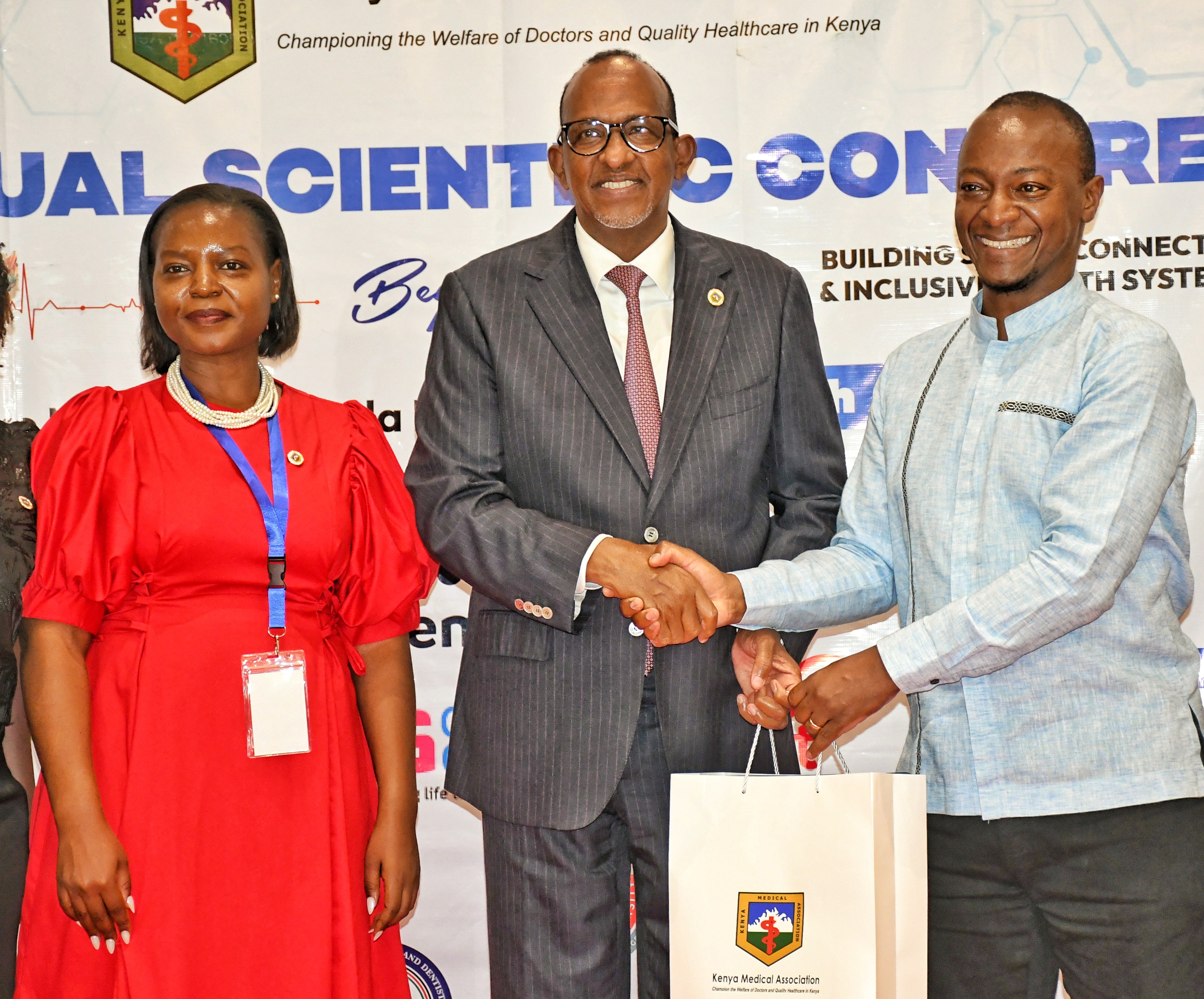 Health Cabinet Secretary Aden Duale (centre) receives a gift from the Kenya Medical Association President Dr. Simon Kigondu (left) during the 53rd Kenya Medical Scientific Conference held in Naivasha