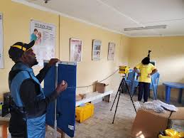 A health technician conducting TB screening using modern diagnostic equipment  at a public facility in Kenya.