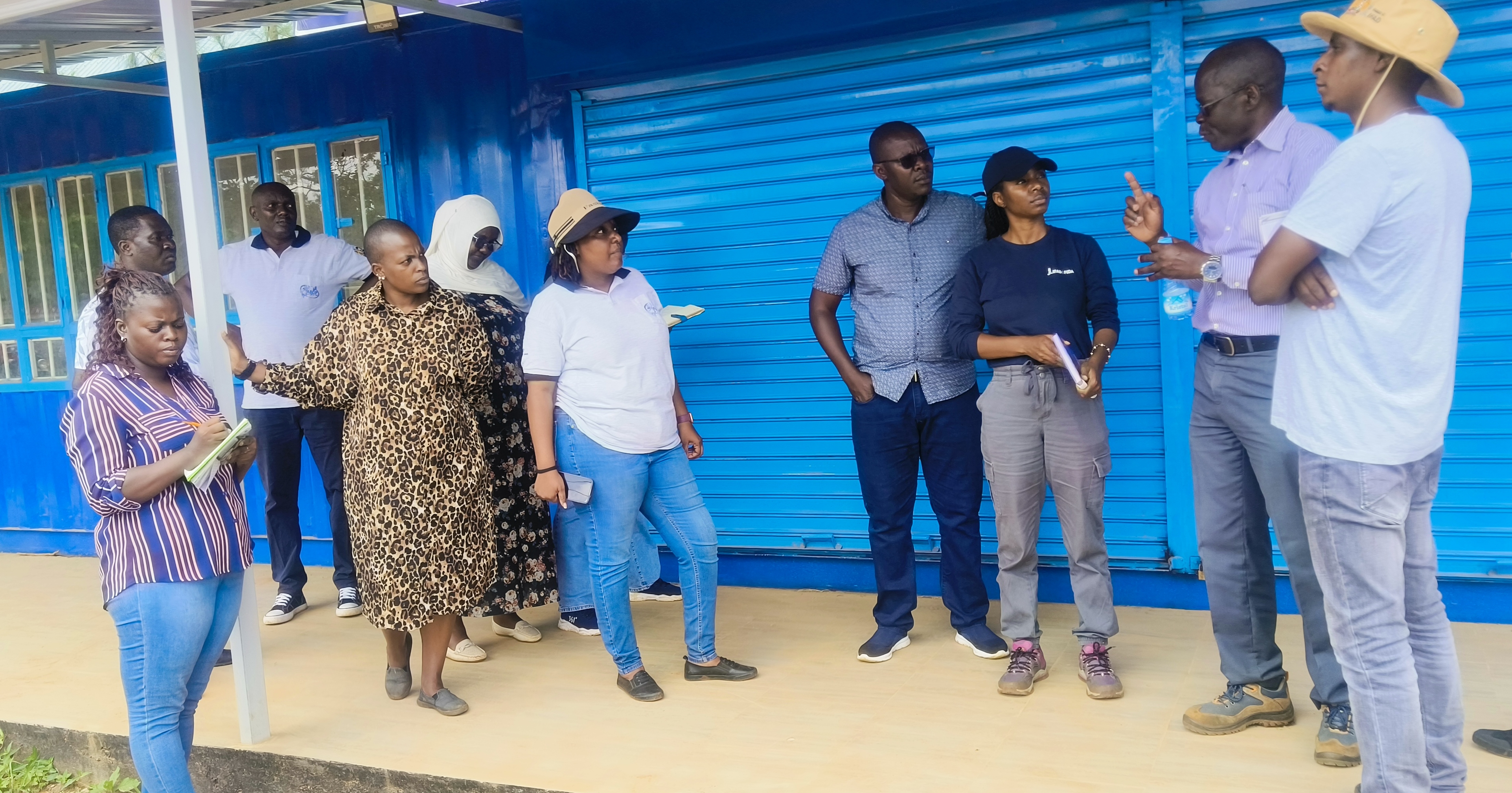 Vihiga County Project Coordinator Wilson Munala (23rd from Right) briefs stakeholders on the fish processing kiosk during a site visit at Kaimosi Vocational Training Centre.