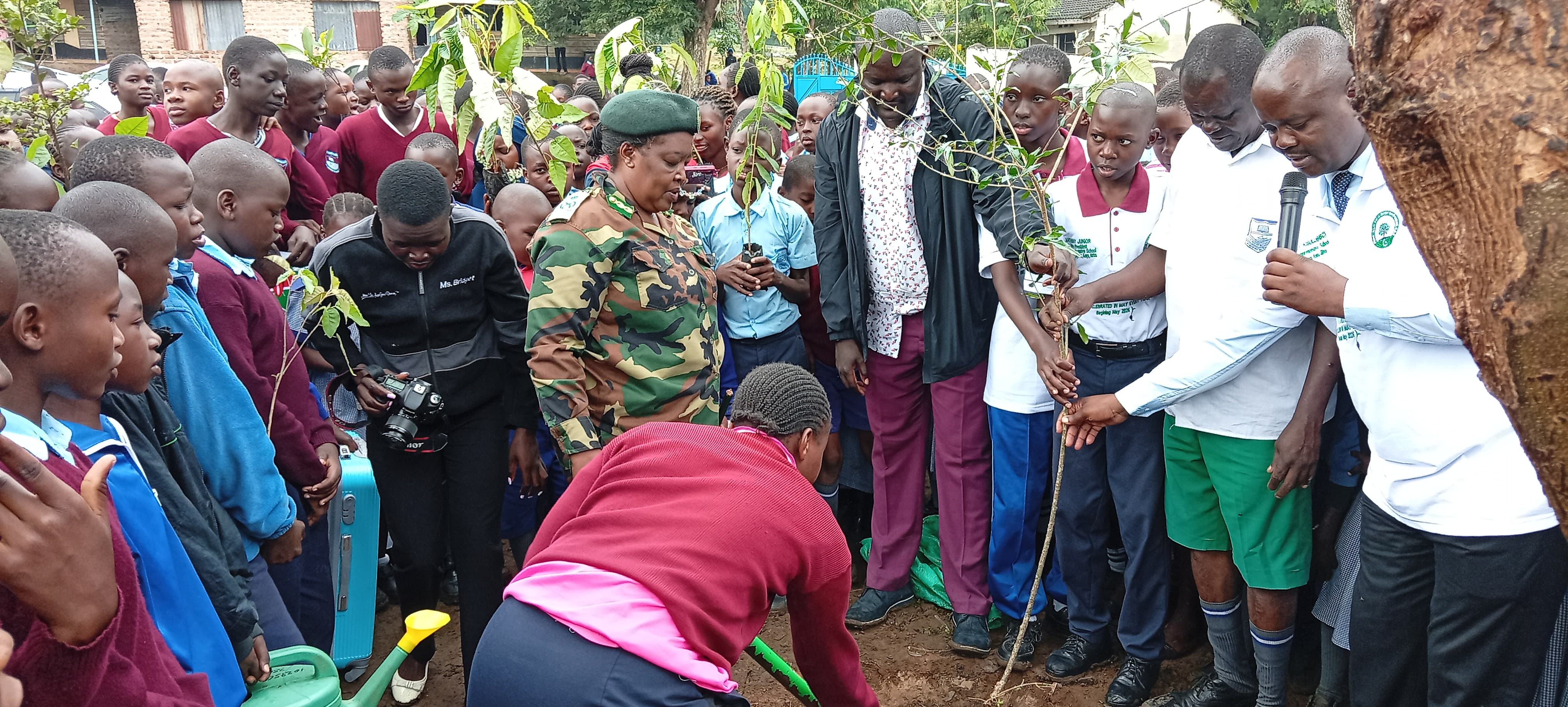 Homa Bay County Chief Conservator, Sharon Cheluget (second left), Commissioner Eli Kisulu, Tree Ambassador and Nuhu Omollo Masoud, Patron, Plant trees for a better Environment CBO during a tree planting initiative at Lake Primary School in Homa Bay town.