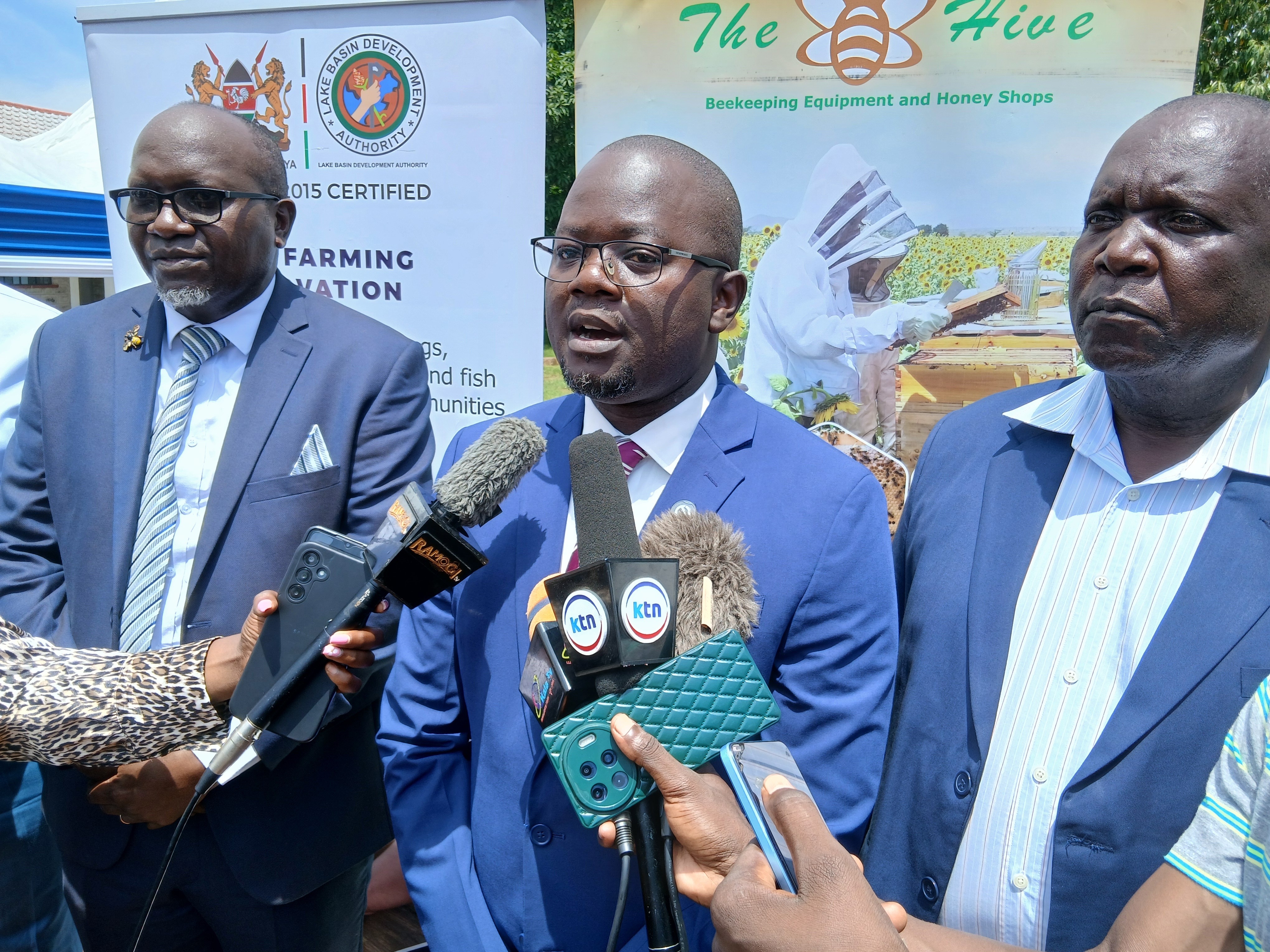 LBDA MD Wycliffe Ochiaga (in blue suit) presents a beehive to one of the beneficiaries during the launch of the project in Kisumu 