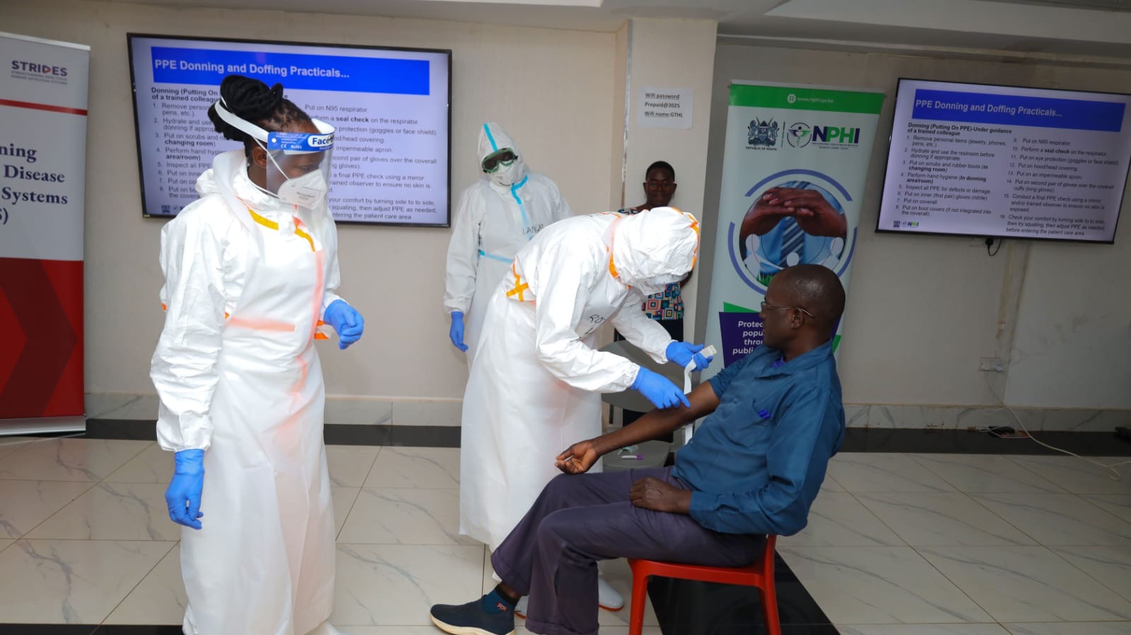 Kenya National Public Health Institute (KNPHI) staff demonstrating PPE donning and doffing practical training session