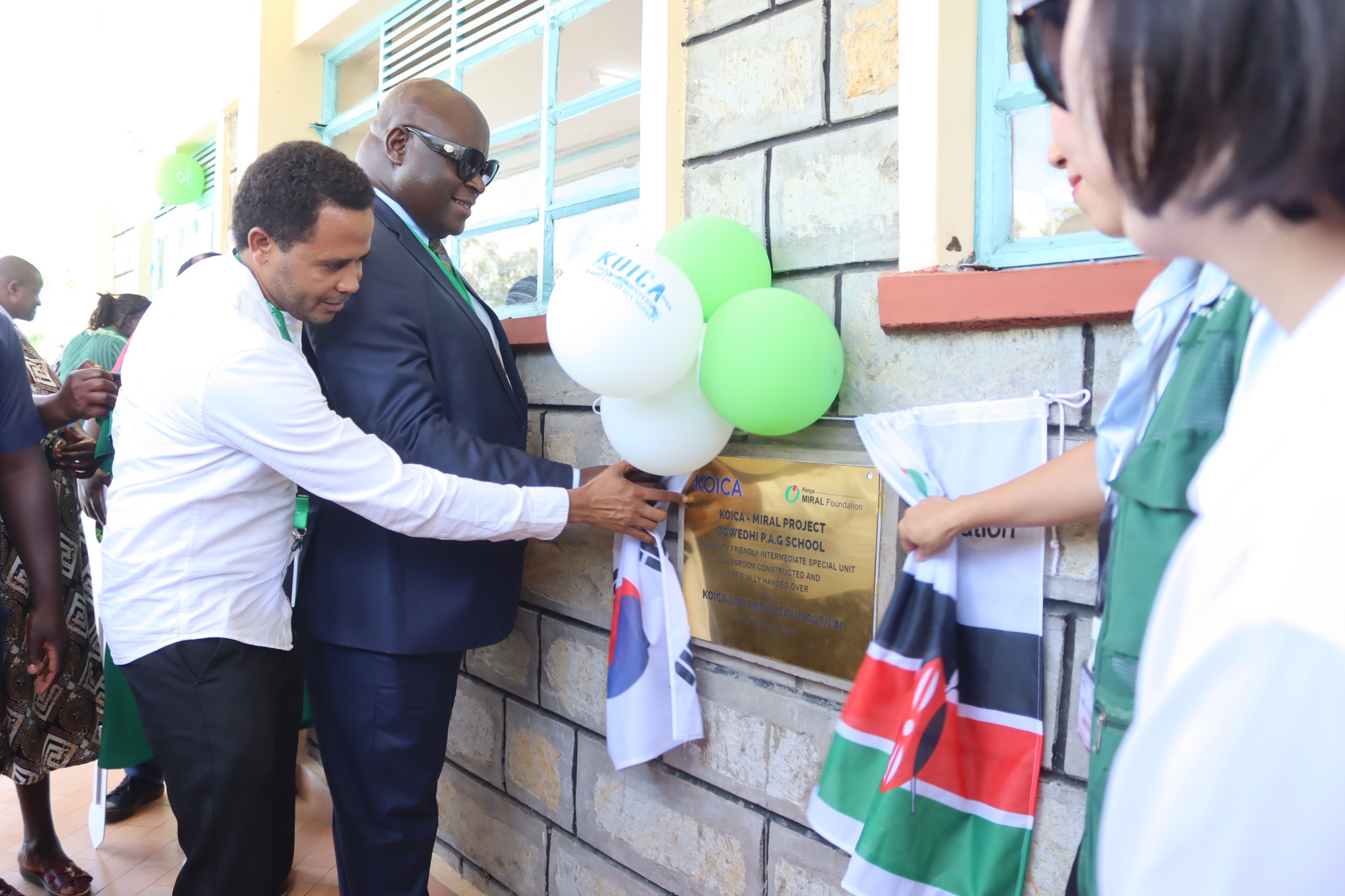  The Kisumu County Chief Officer for Education, Bovince Ochieng, (Left), Director of the Special Needs Education, Fredrick Haga (in blue suite) joined by the leadership from KOICA and Miral Welfare Foundation during the handing over ceremony of the new Intermediate Special Education Classroom at Ogwedhi PAG Primary School in Nyando Sub-County, Kisumu County