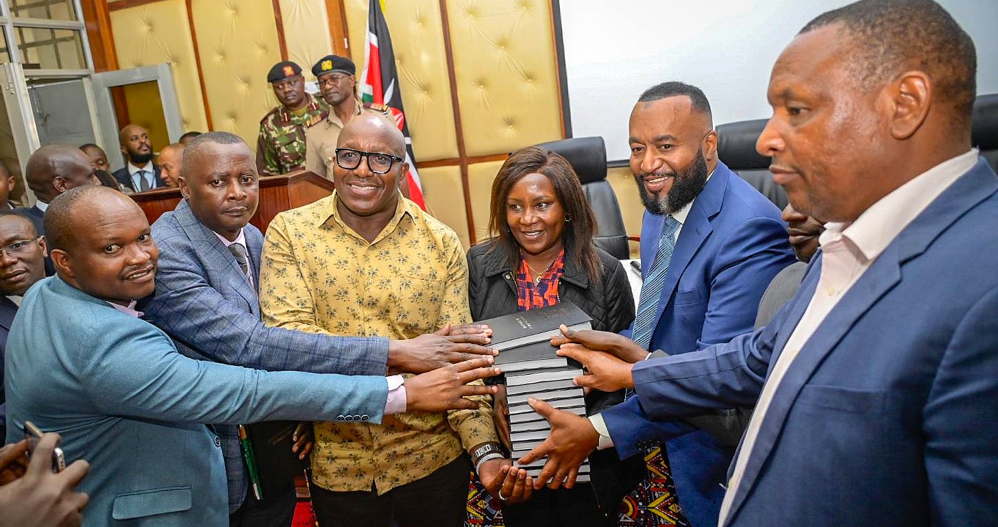 Cabinet Secretary (CS) for Mining, Blue Economy and Maritime Affairs Ali Hassan Joho (third from right) handing over copies of Mining Act to Embu County officials led by Governor Cecily Mbarire (next to him)