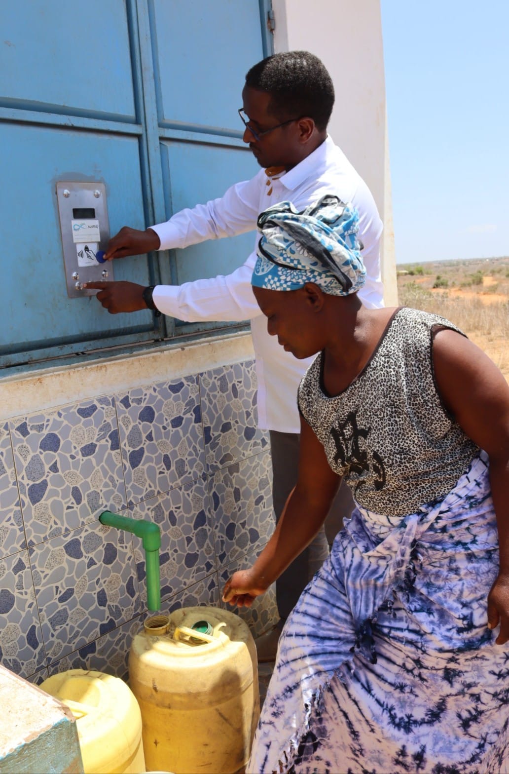  National Drought Management Authority (NDMA) Chief Executive Officer Aden Hared draws water from the automated water dispensing (ATM) kiosk at Roka in Mackinnon Road Ward, Samburu Sub-County, Kwale County, during inspection of the Taru–Roka–Egu–Kwa Kalinga Water Pipeline Extension Project.