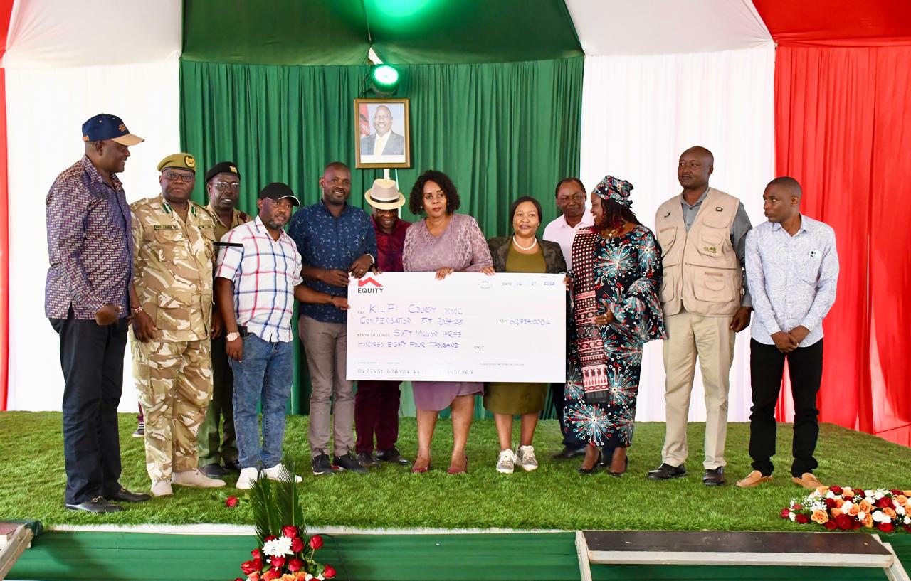Leaders display a dummy cheque of Sh60,384 million. Tourism and Wildlife Cabinet Secretary, Rebecca Miano, handed over actual cheques to 24 families of victims of human-wildlife conflicts between 2014 and 2020.