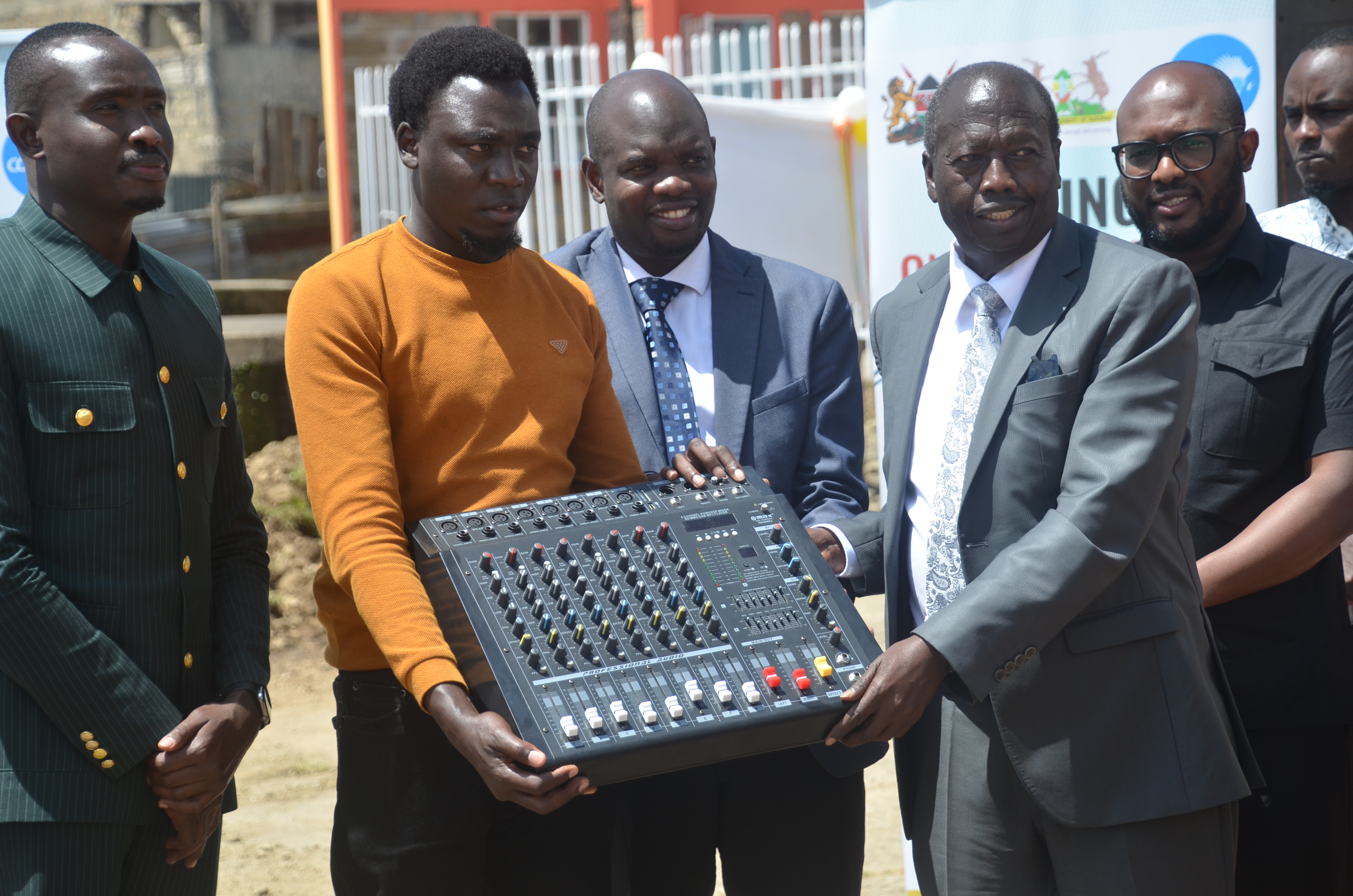 Baringo Governor Benjamin Cheboi hands over a studio mixer to a youth representative during the launch of Kabarnet One Stop Youth Centre within the County headquarters. Photo/Benson Kelio
