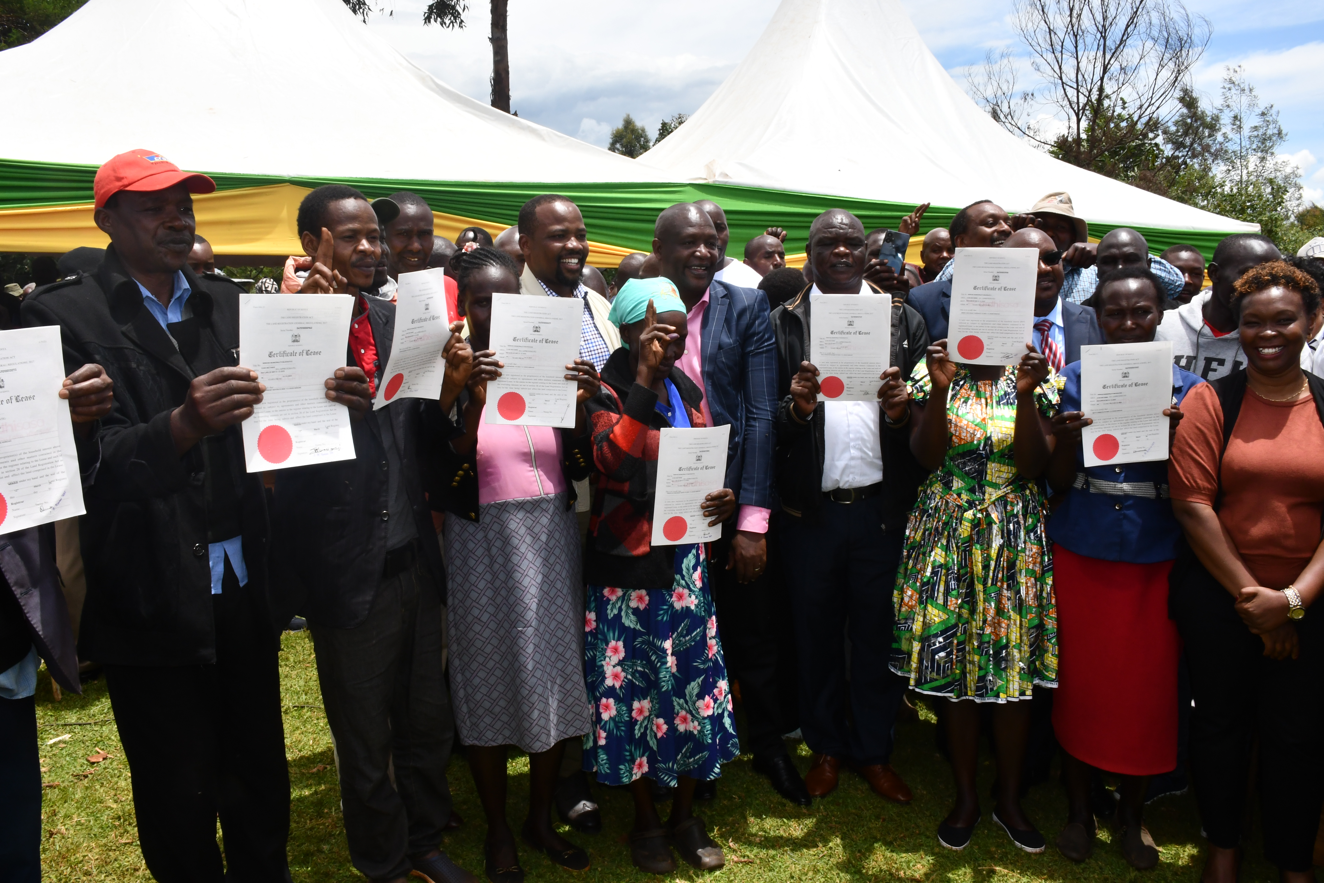 Some of the Chelimo residents proudly display their newly acquired title deeds 