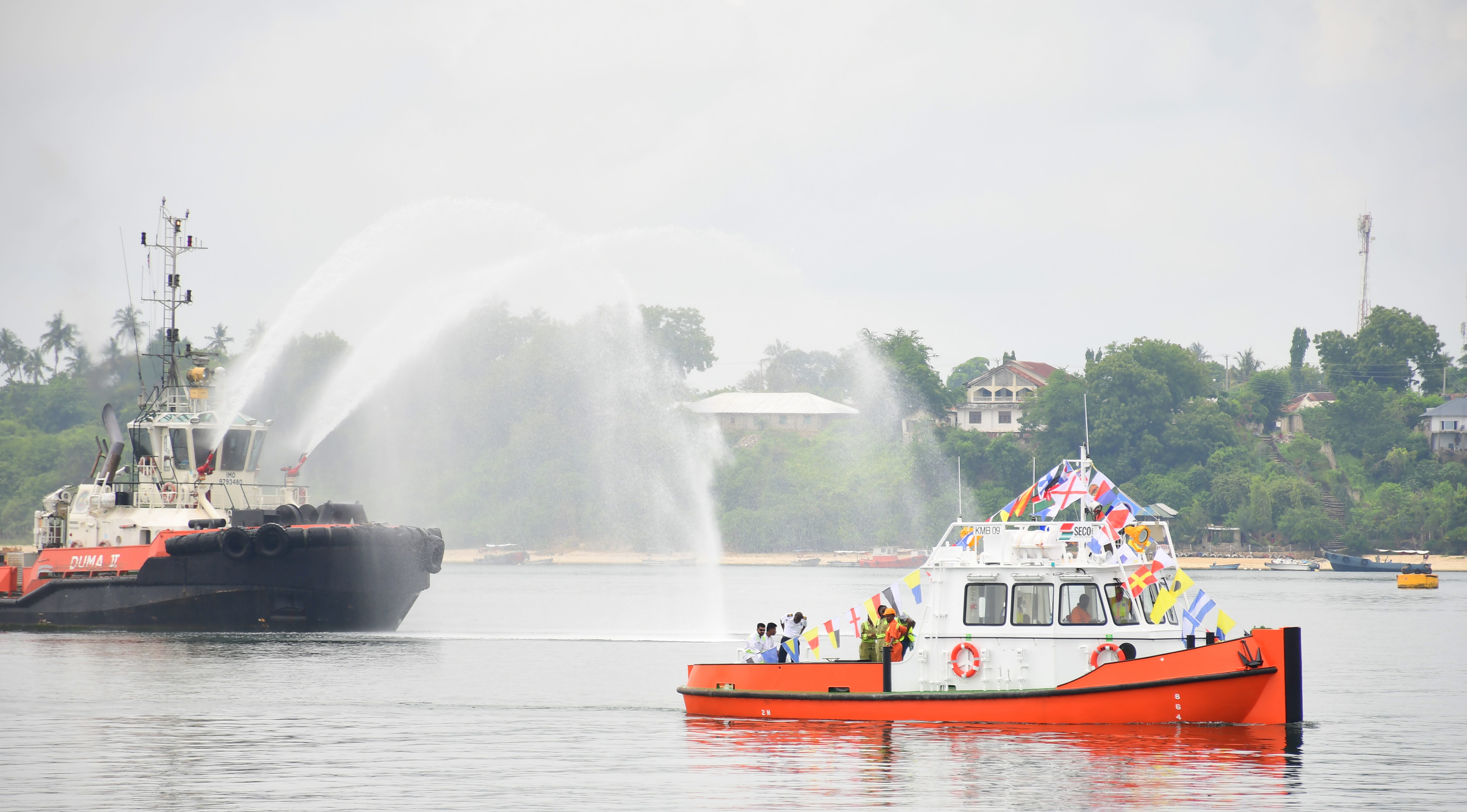 The first ever locally manufactured mooring boat (front) receives a water salute during its commissioning at the Kenya Ports Authority (KPA) Marine Pontoon at the Port of Mombasa