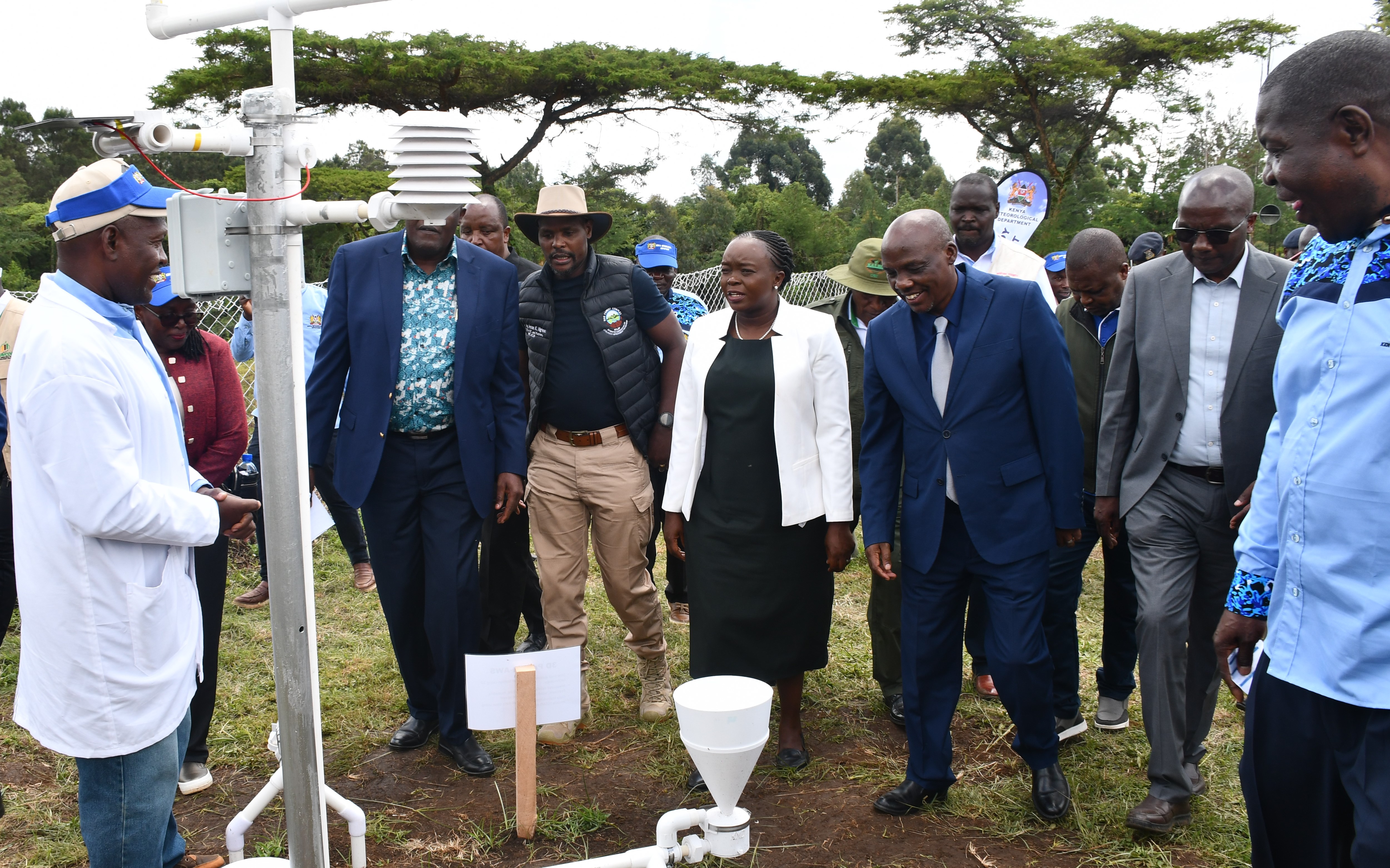 A Meteorologist (left) explains how a set of rain gauges work to Cabinet Secretary (CS) for Environment, Climate Change and other dignitaries during celebrations to mark the World Meteorological Day in Njoro, Nakuru County.