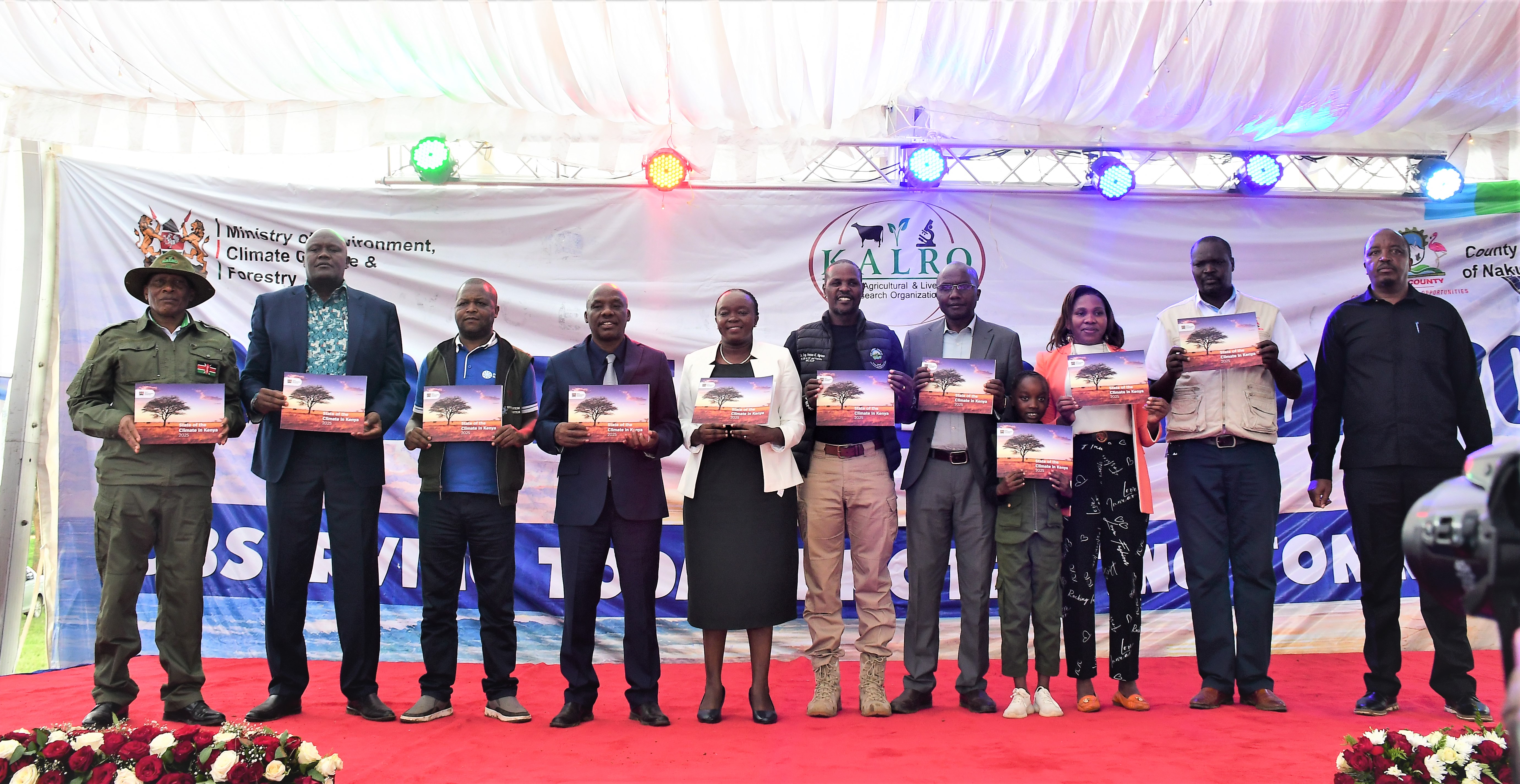 Cabinet Secretary (CS) for Environment, Climate Change and Forestry Dr Deborah Mlongo Barasa (fifth left) and other government officials display a 2025 Kenya Meteorological report and action plan after the launch at KALRO, Njoro Centre in Nakuru