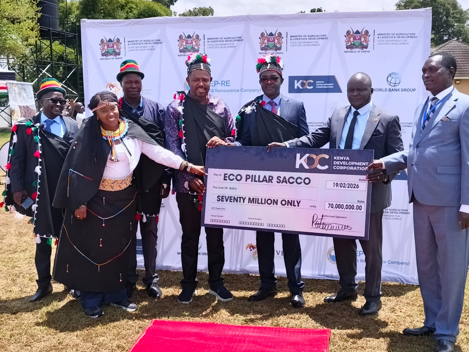 Principal Secretary Abubakar Hassan Abubakar, Governor Simion Kachapin, KDC Director General Norah Ratemo, and other officials present the cheque to Eco Pillar CEO at the Governor’s residence in Kapenguria.