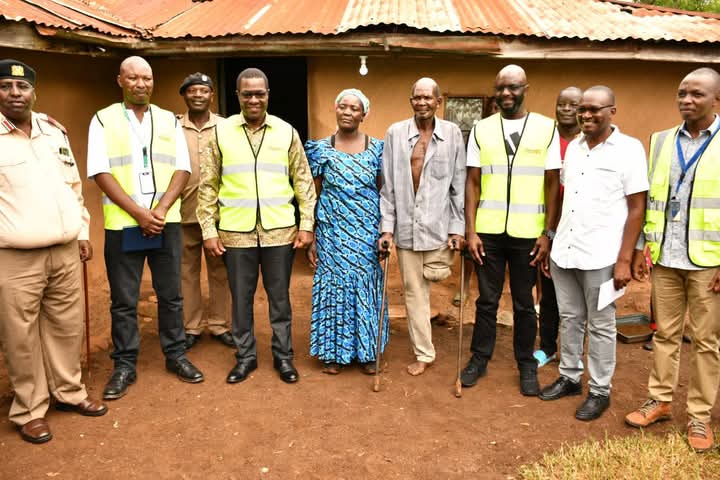 CS Wandayi joins Obambo Kadhai villagers in a group photograph after commissioning a rural electrification project in the village