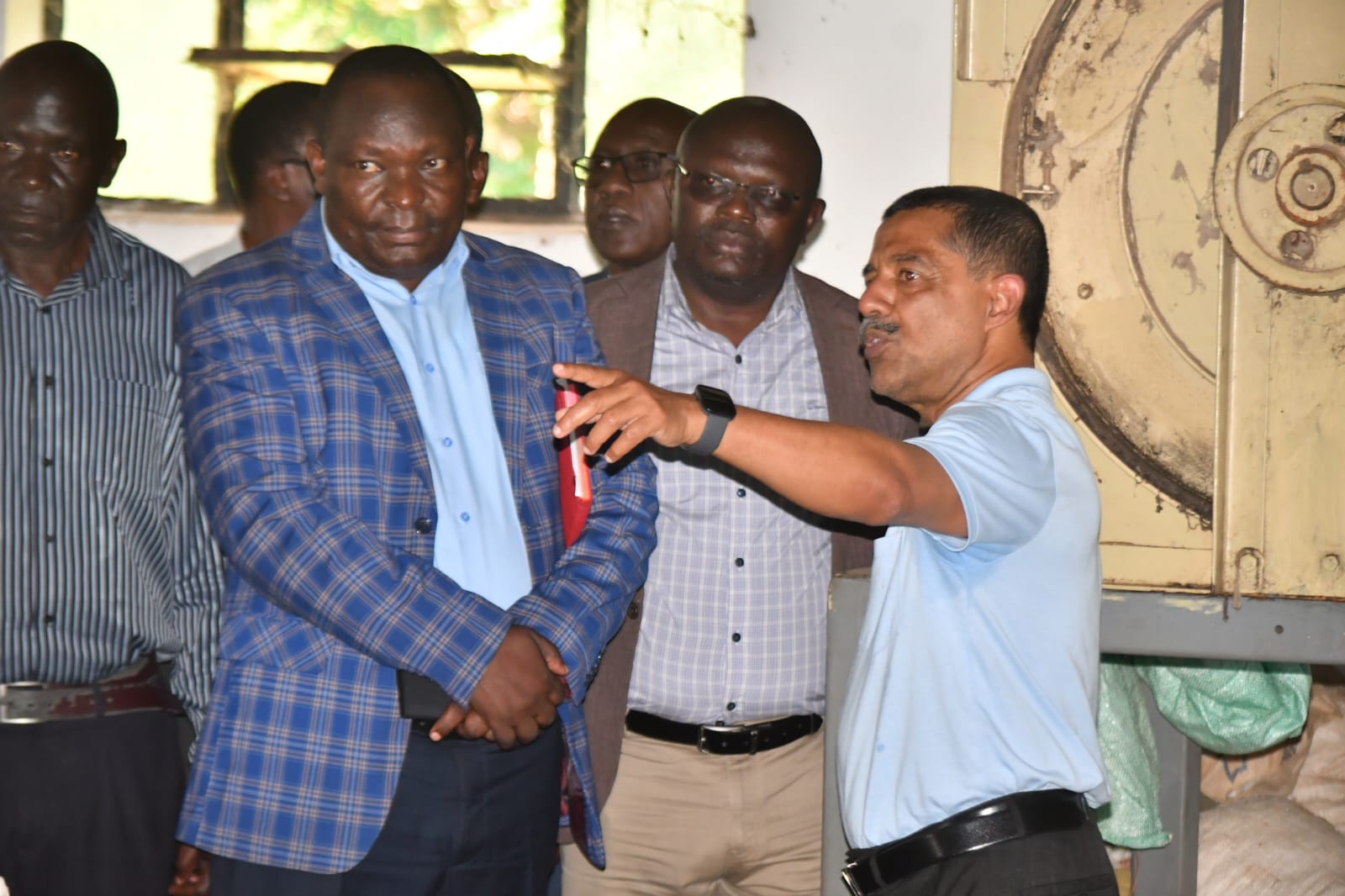 State Department for Cooperatives Secretary Administration Amos Mariba (in checked blue  court) during the Luanda Ginnery site handing over ceremony to the contractor. PHOTOS BY CHRIS MAHANDARA