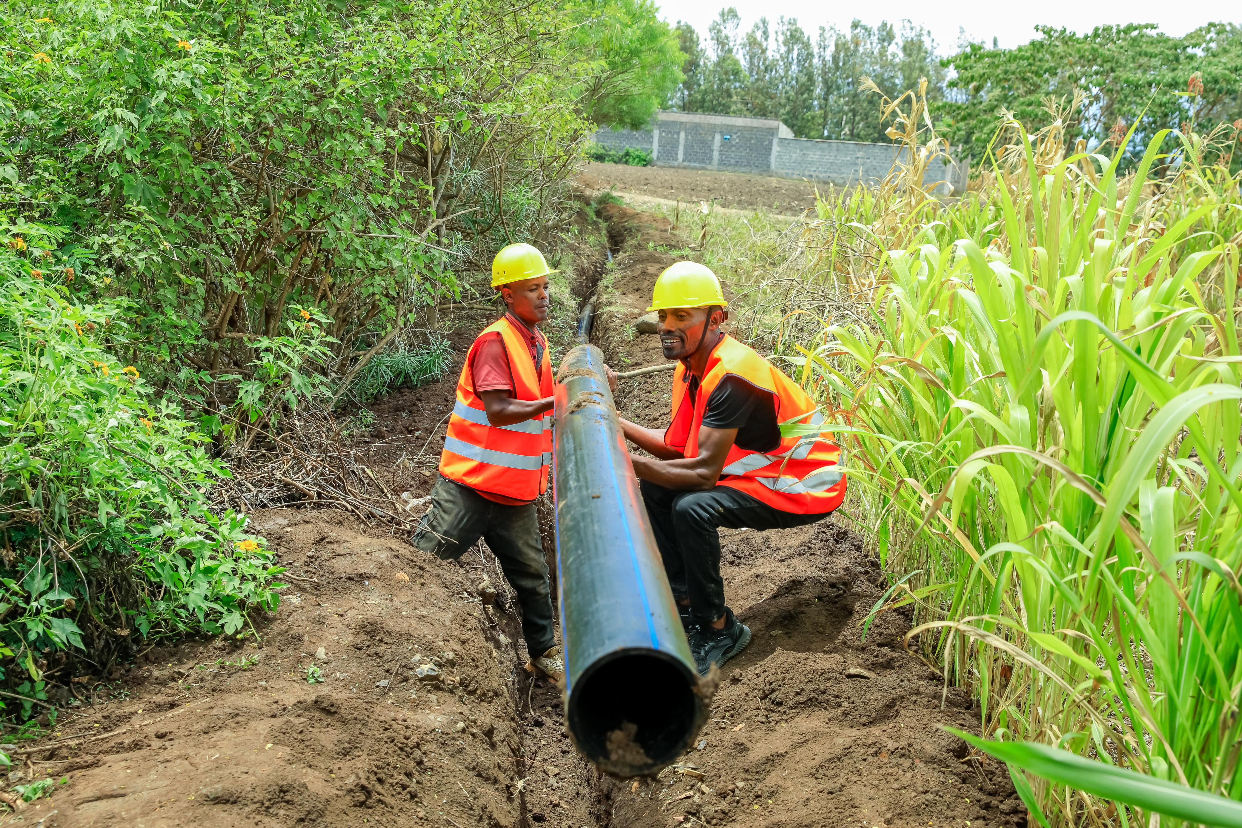 Workers installing water pipes in Mwea Sub-County.