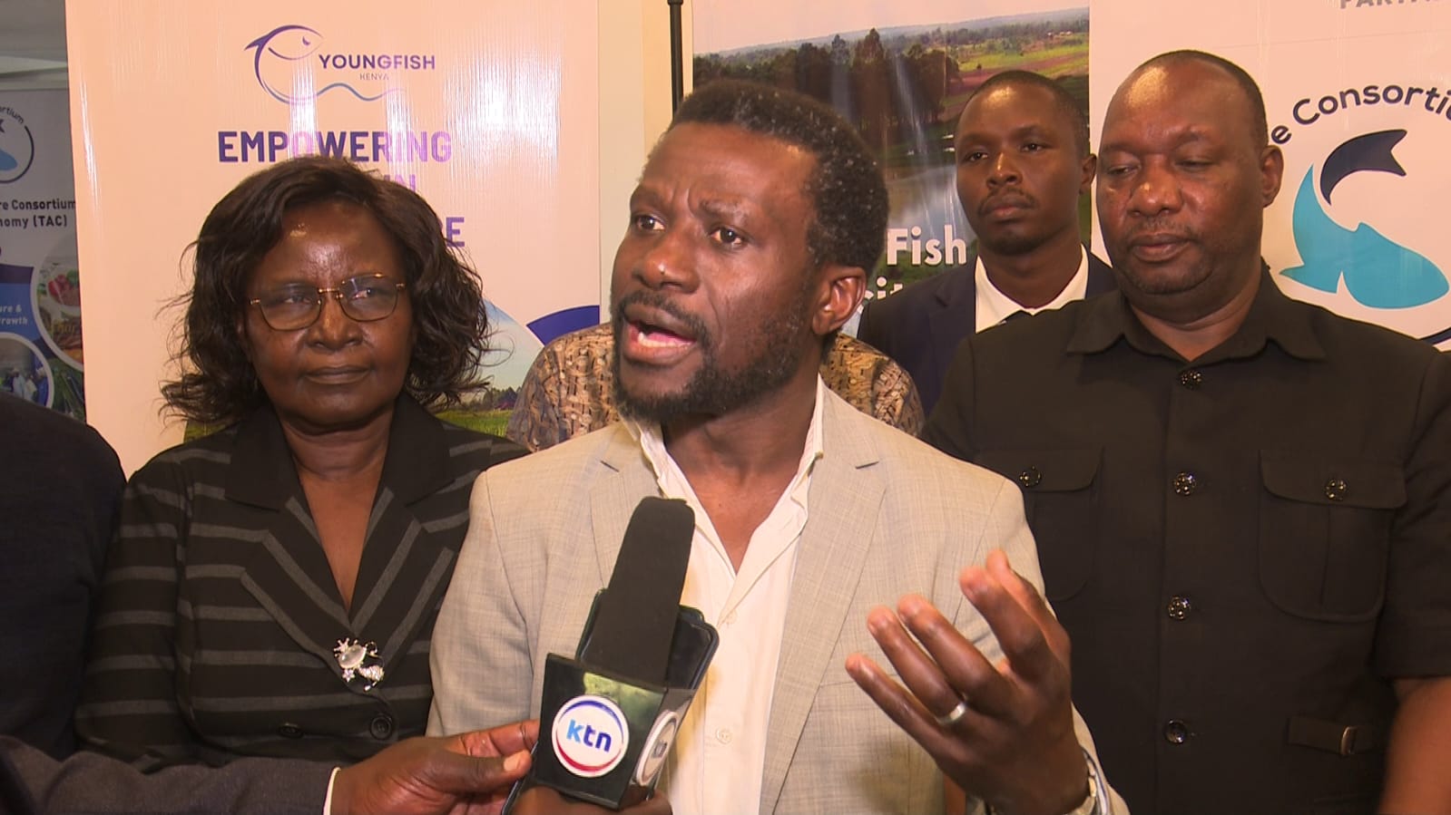 The Aquaculture consortium CEO Mr. Felix Osok addressing the media during the launch of youth led initiatives to bridge fish deficit in the country. He is flanked by Kisumu County Education Director Rosemary Birenge and Blue Economy regional coordinator Samson Kidera.