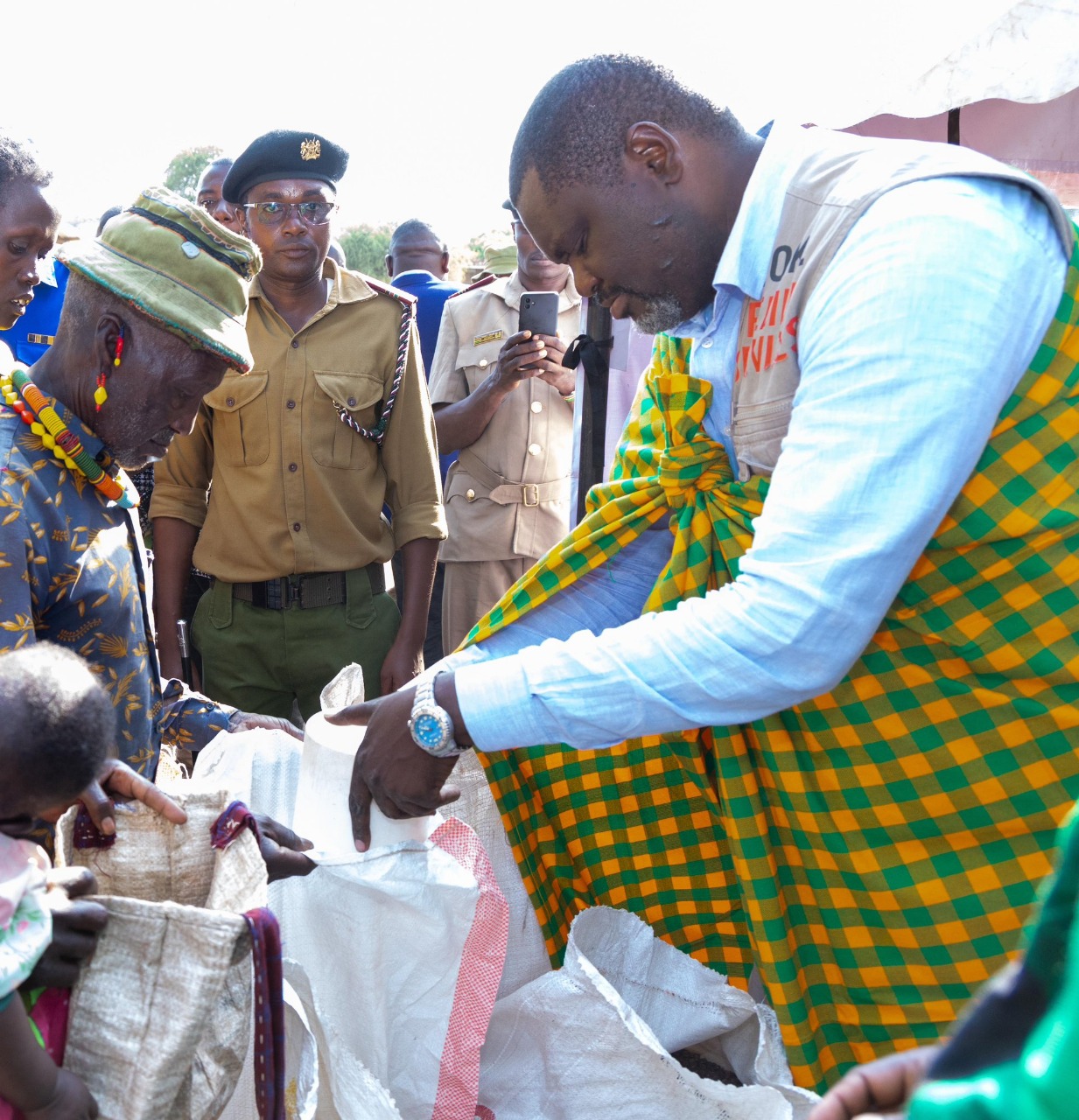 Cabinet Secretary for Public Servic,e Geoffrey Ruku, handing over foodstuffs to residents of Chemolingot, Tiaty Constituency during a government relief distribution exercise aimed at supporting vulnerable households.