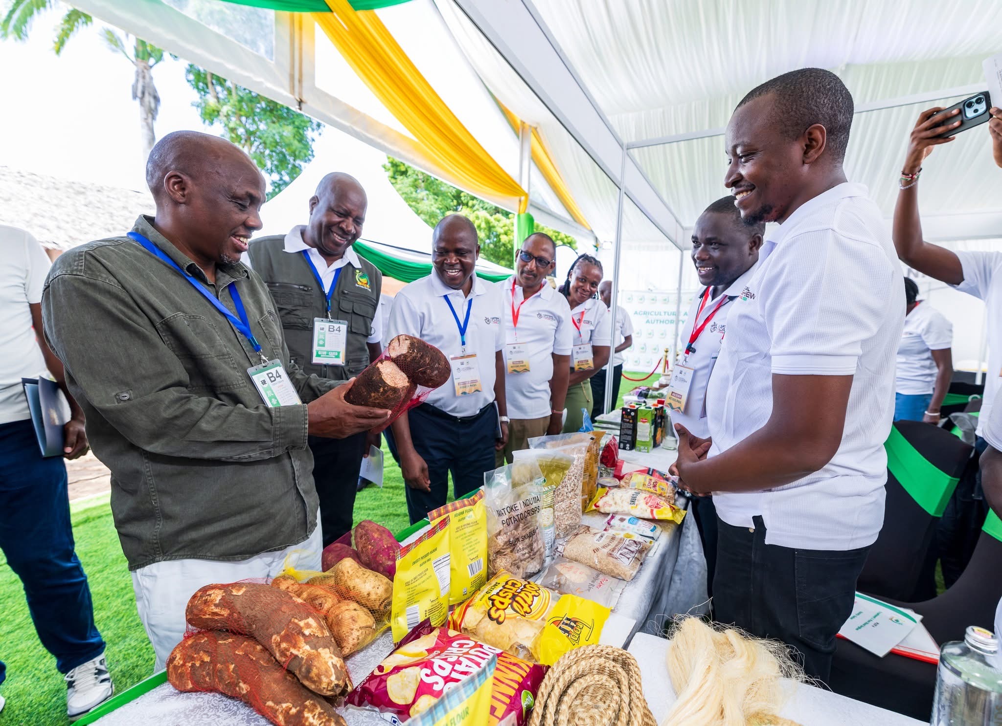 Agriculture PS Dr. Paul Ronoh (left) tours an exhibition stand showcasing various farm produce during a national agricultural forum in Kwale County, PHOTO: CHARI SUCHE