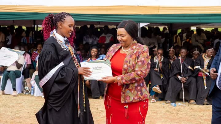 Cabinet Secretary for Tourism and Wildlife Rebecca Miano issues a certificate to a student from Wildlife Tourism College of Maasai Mara.