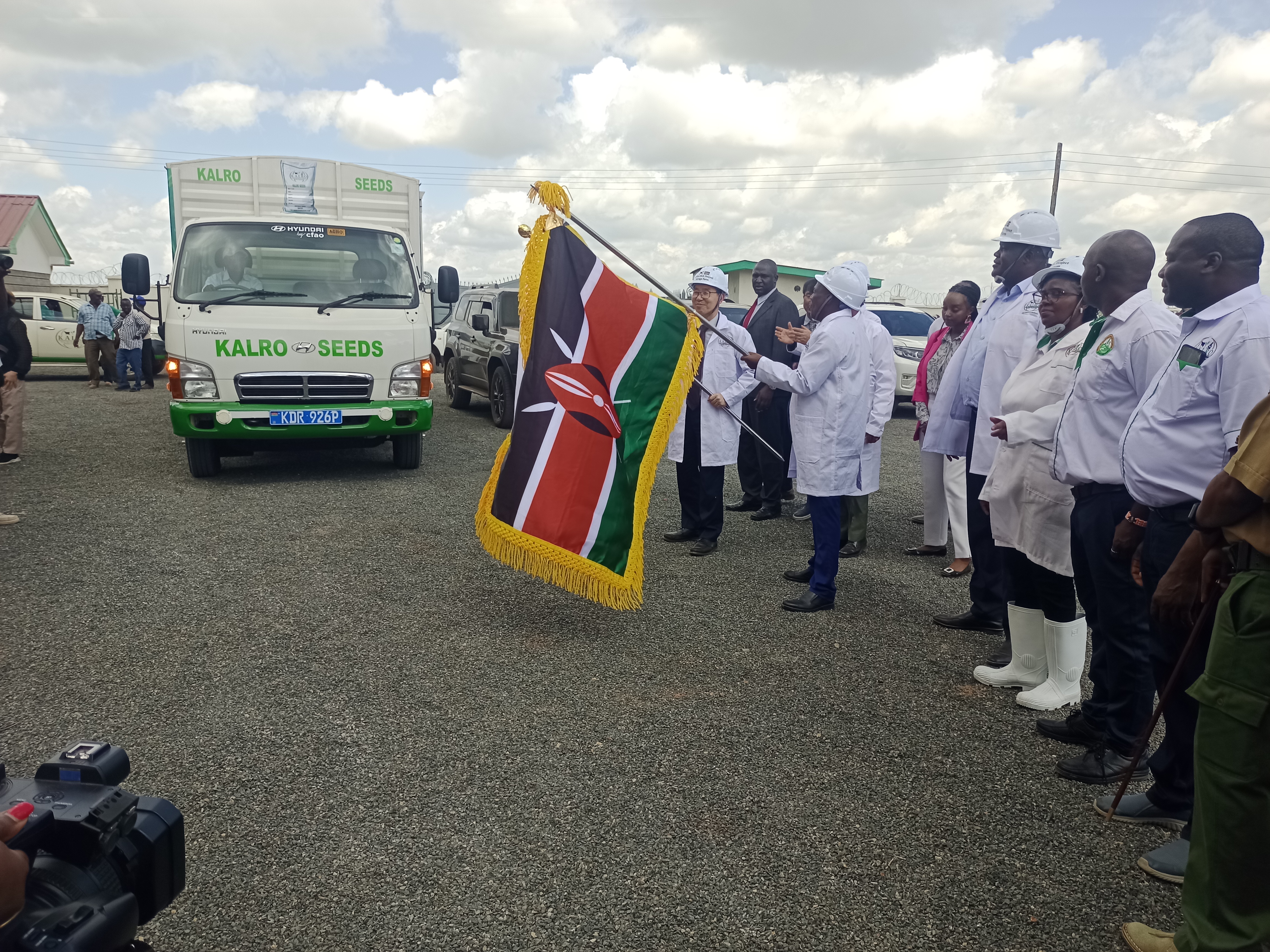 Agriculture Principal Secretary Dr. Paul Kipronoh Ronoh, South Korean Ambassador to Kenya Kang Hyung-shik, directors from various departments, and farmers inspecting rice seeds at the facility in Mwea.