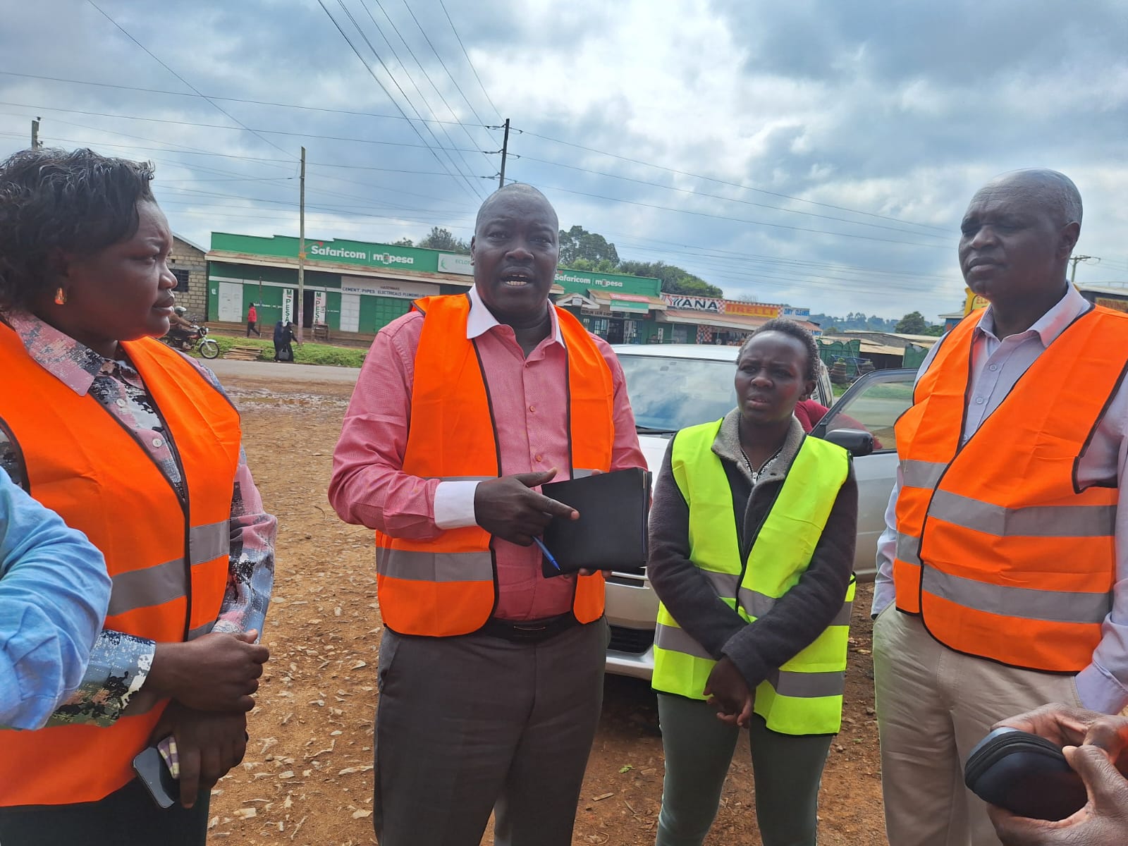 Uasin Gishu Chief Officer for Housing and Urban Development, Mary Kerich (left), Chief Officer for Lands, Julius Koech (center), and County Executive Committee Member (CECM) for Lands, Physical Planning, Housing and Community Development, Edward Sawe (right), during an inspection tour in Eldoret, Uasin Gishu County.