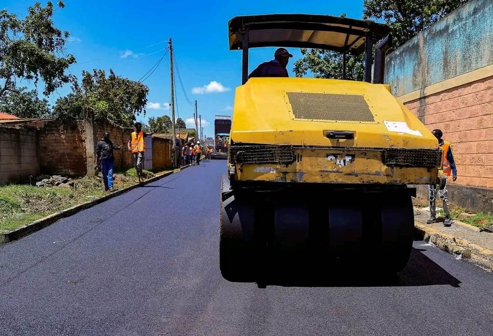 Uasin Gishu County Governor Dr. Jonathan Bii Chelilim atop a bitumen paver machine during the inspection of the ongoing 4-kilometer Maili Nne Road upgrade in Turbo Sub-County, Uasin Gishu County.