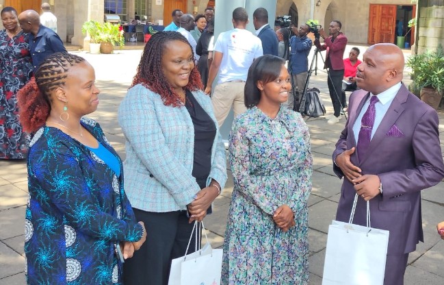 Principal Secretary for Labour and Skills Development Shadrack Mwadime (right) speaking to stakeholders during the consultation on ILO Conventions 189 and 190 at All Saints Cathedral Hall, Nairobi.