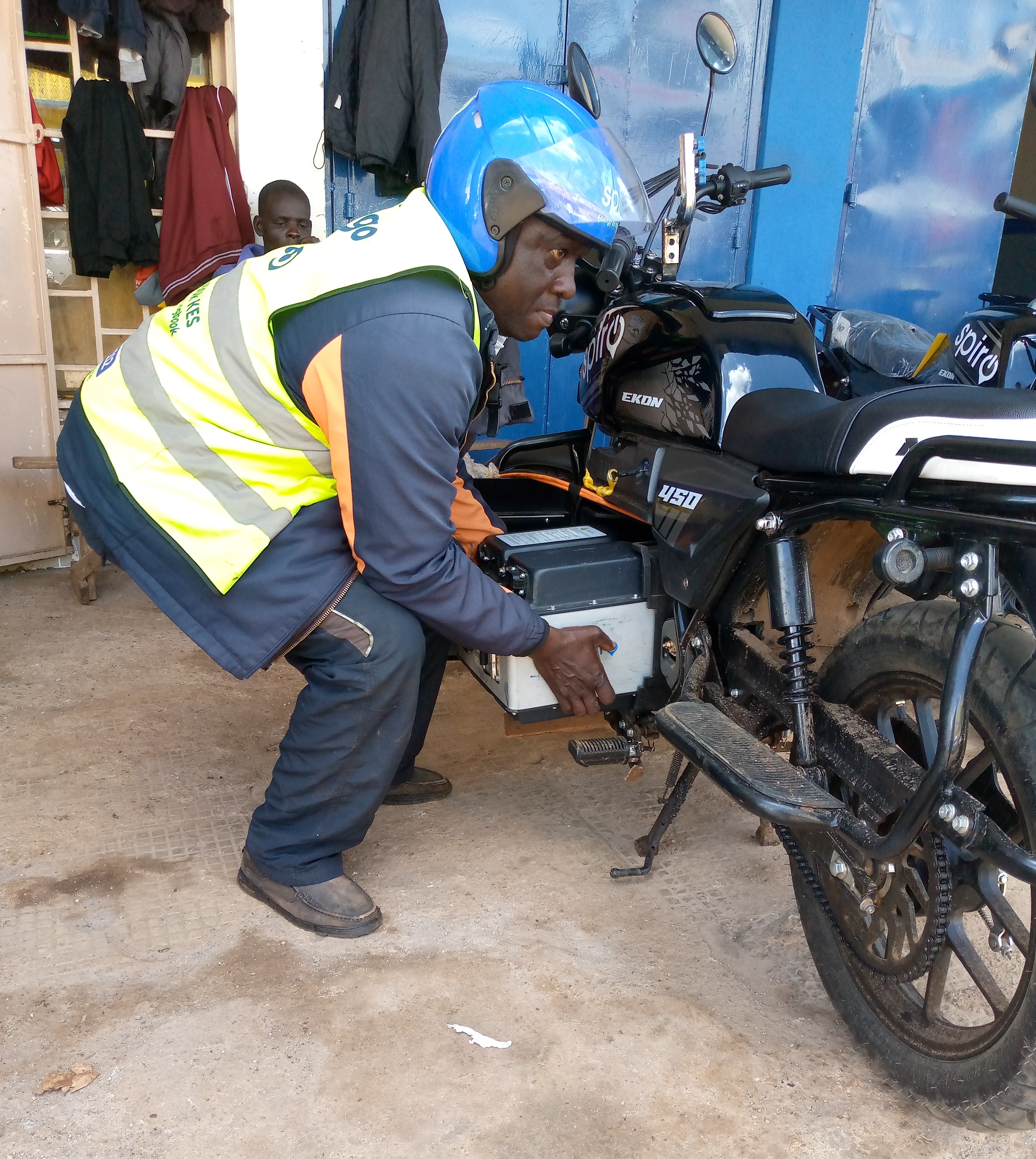 Alfred Makori, a boda boda operator plying the Kericho town service route, removes his electric motorcycle battery for recharging at the Spiro Kericho branch in Kericho town.